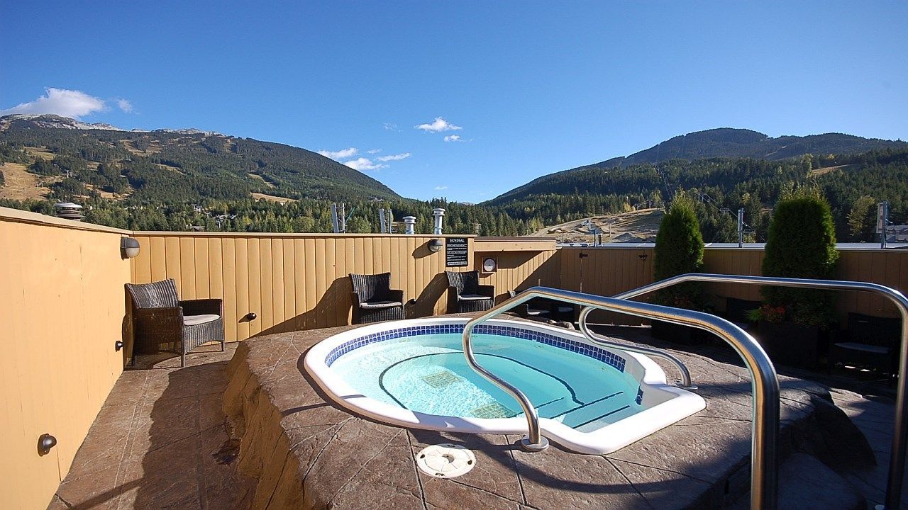 image Soak in the sunshine and stunning mountain views from a private rooftop hot tub.