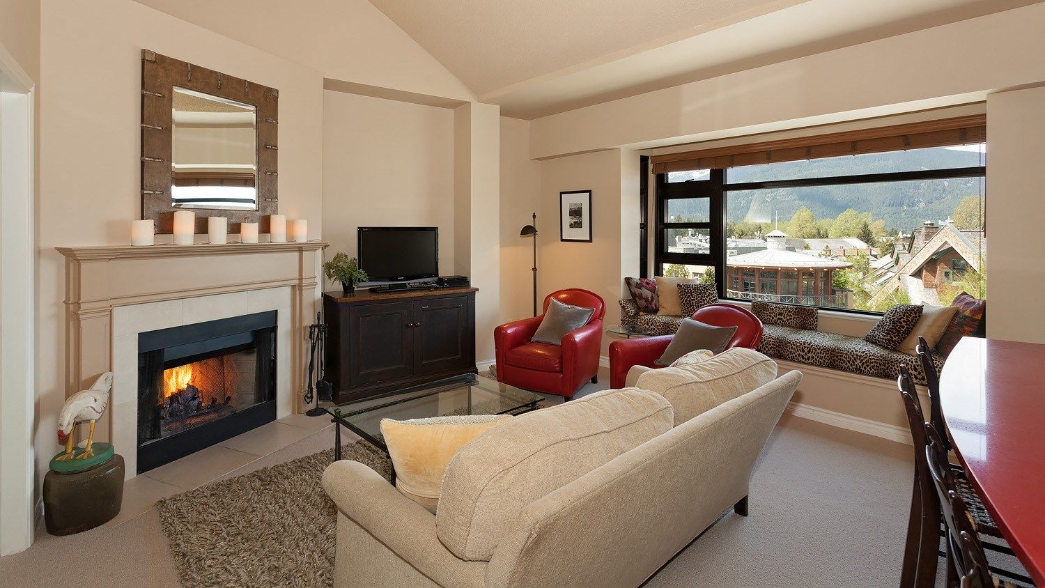 image The living room features a wood burning fireplace and lovely reading area where you can take in the view!