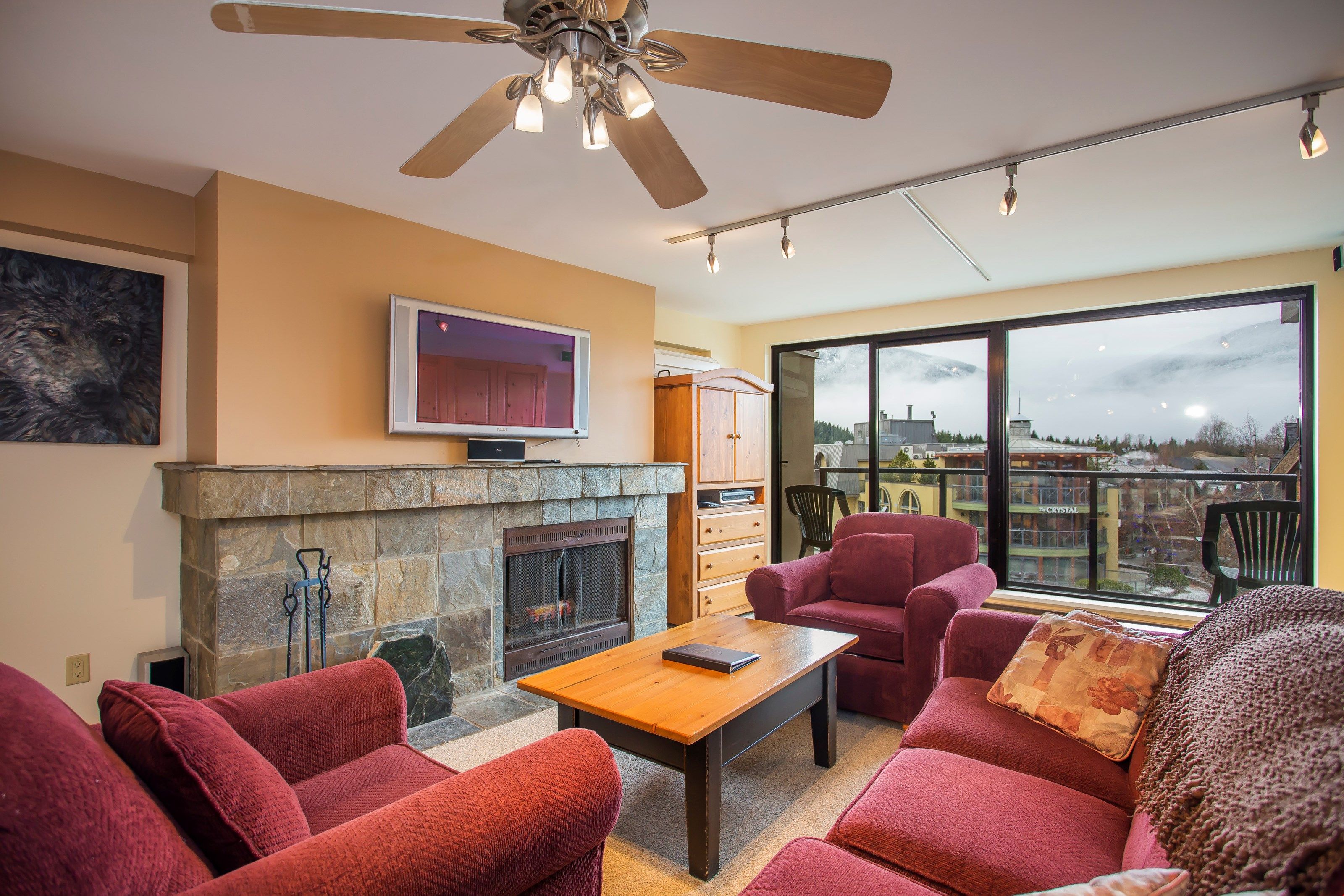 image The living room features a stunning stone wood burning fireplace.