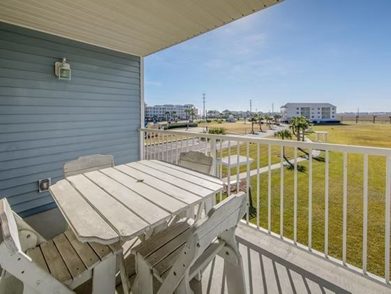 image Savor your morning coffee on the private balcony, where a rustic table welcomes sunny days and gentle breezes