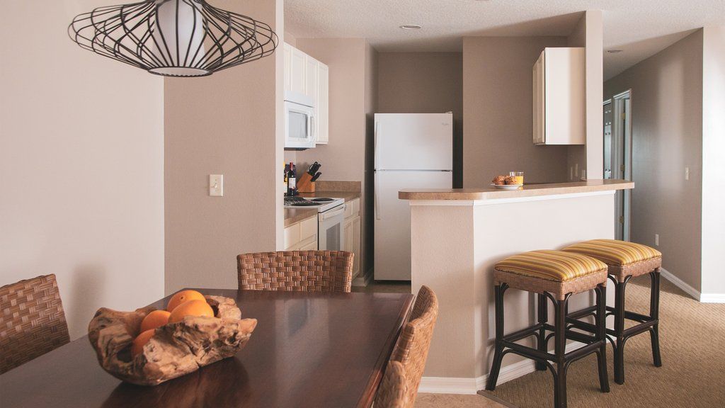 image This family-friendly kitchen and dining area invites you to enjoy meals together, featuring modern appliances and a large dining table, making it easy to fuel up before your adventures at nearby Disney attractions.