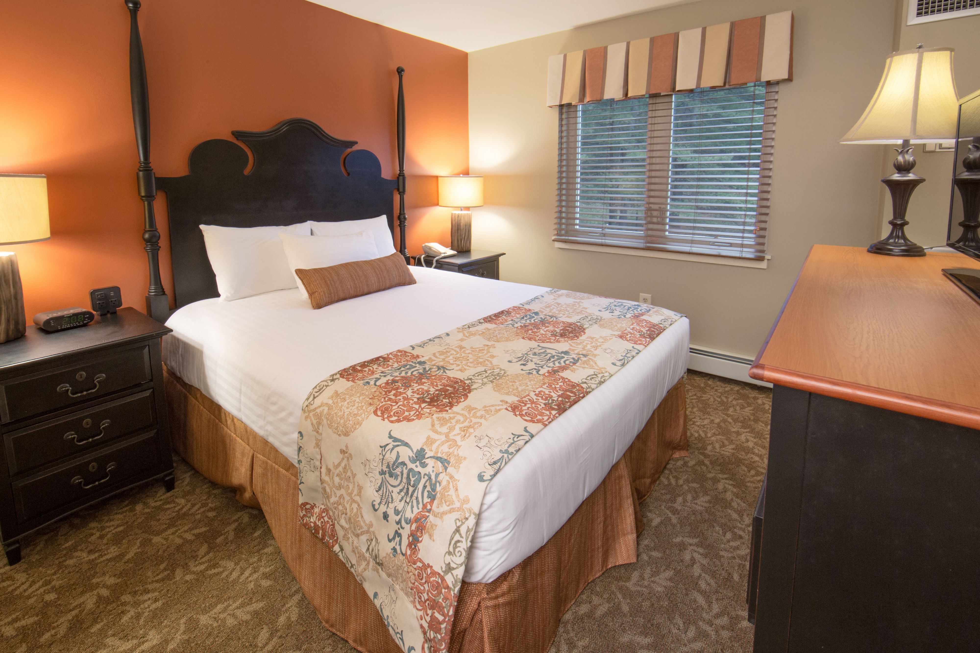 image Bedroom with decorative bedspread and bedside lamps.