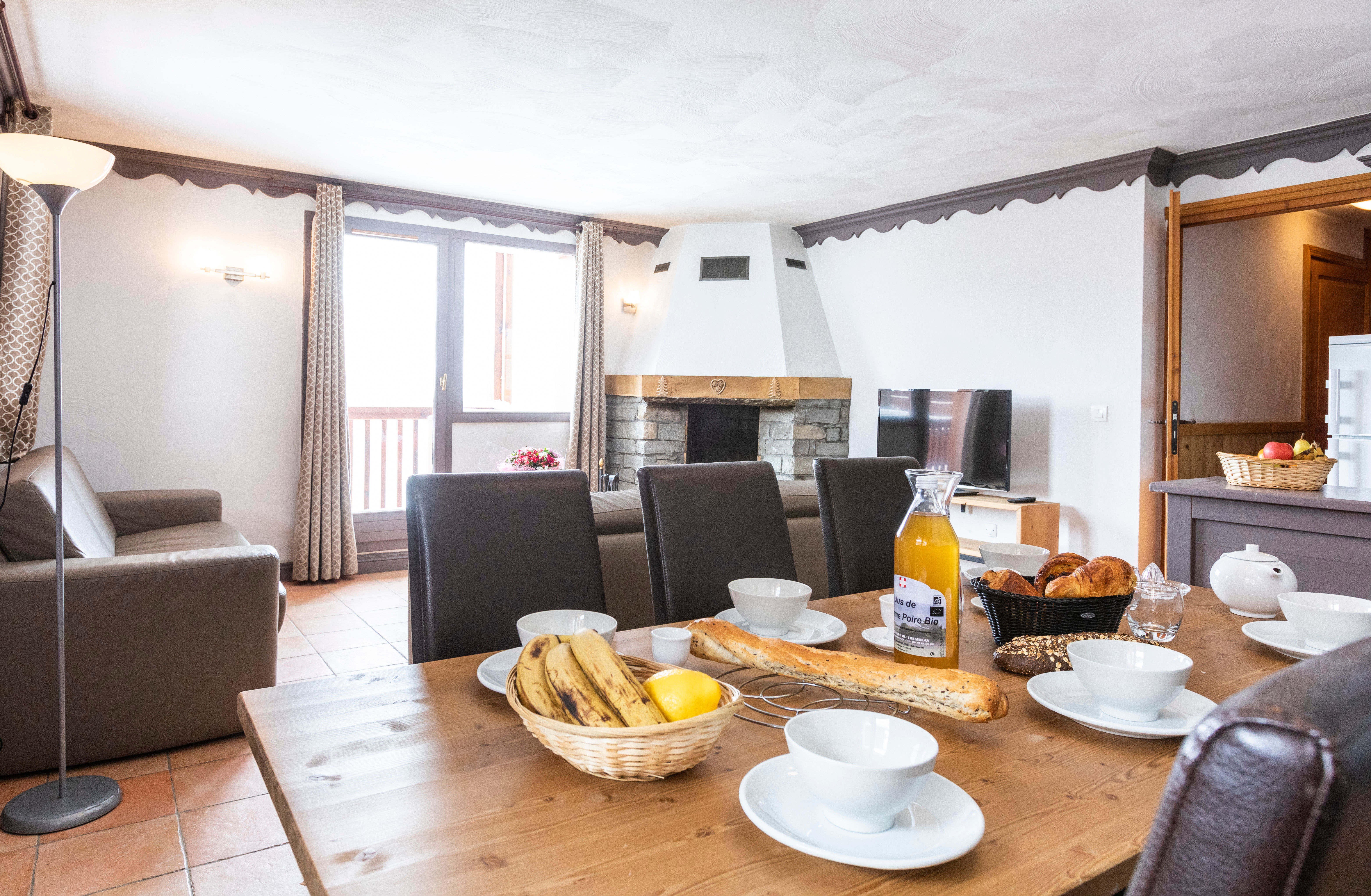image Breakfast beside the stone fireplace.