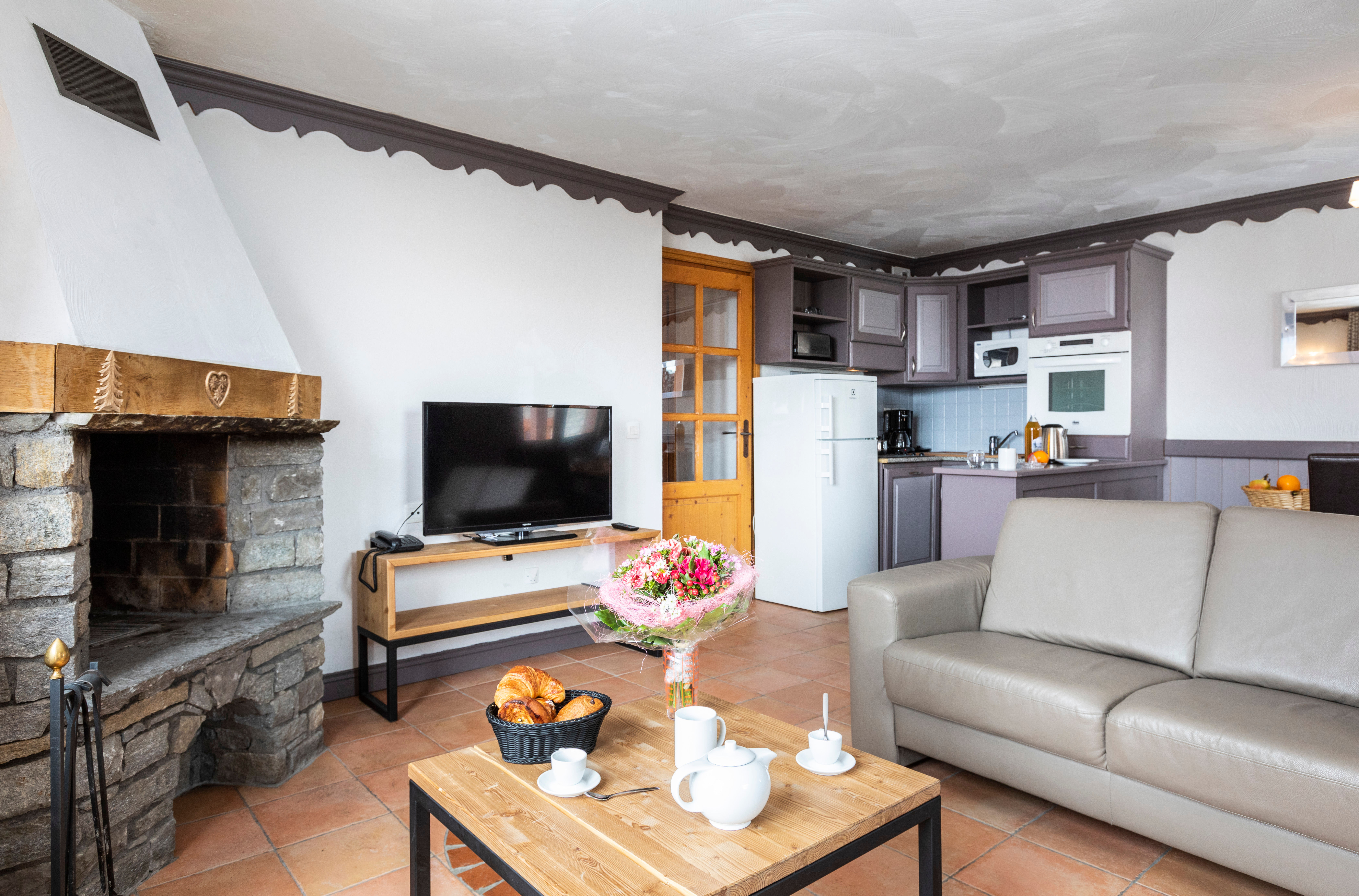 image Relax by the fireplace with the kitchen close by.