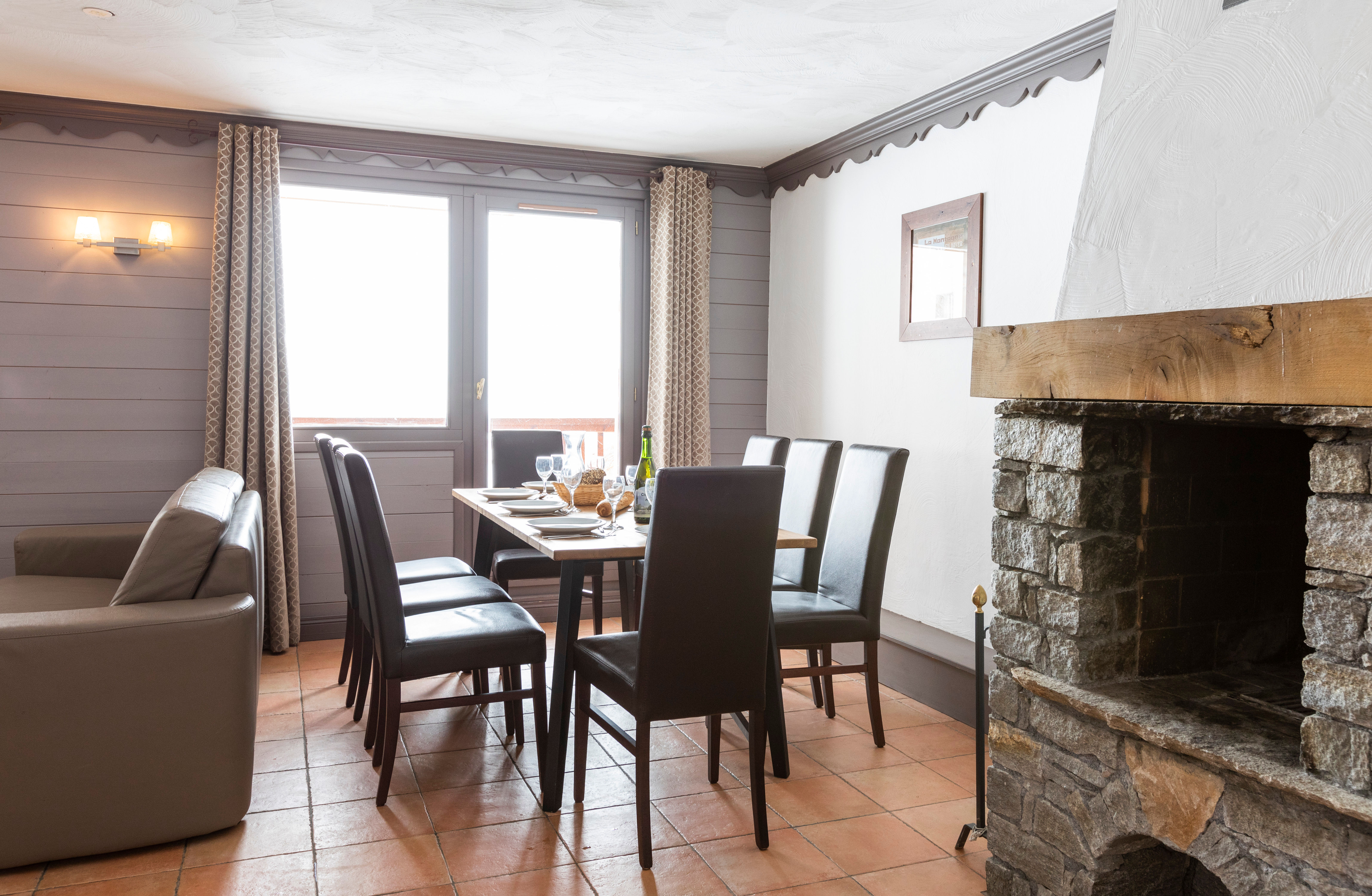 image Gather around the table beside the fireplace.