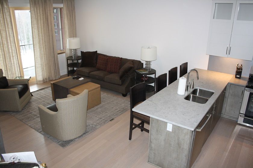 image Gather in the open-concept kitchen and living area designed for comfort and connection.