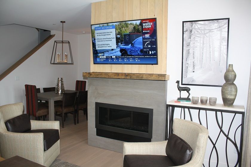 image Relax by the cozy fireplace while enjoying the mounted TV and inviting seating.