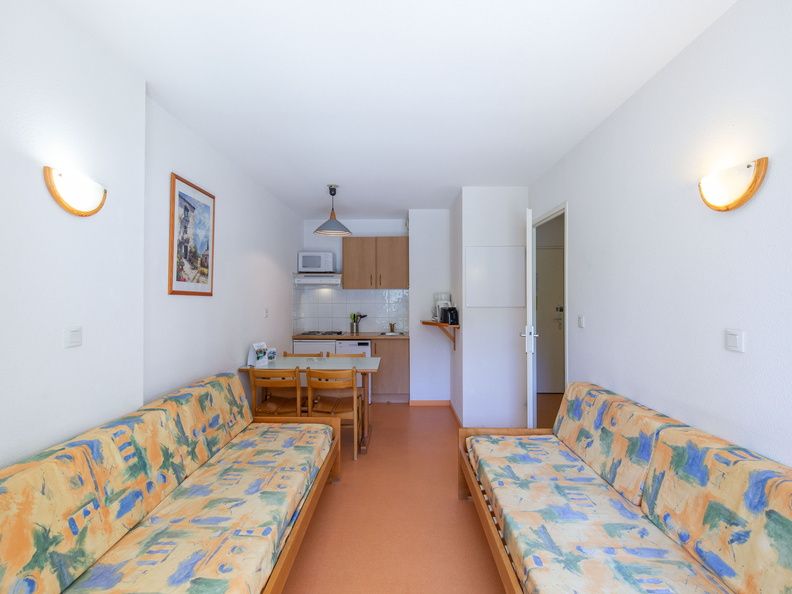 image The charming living area features comfortable seating and a convenient kitchenette, ideal for relaxing after a day on the slopes.