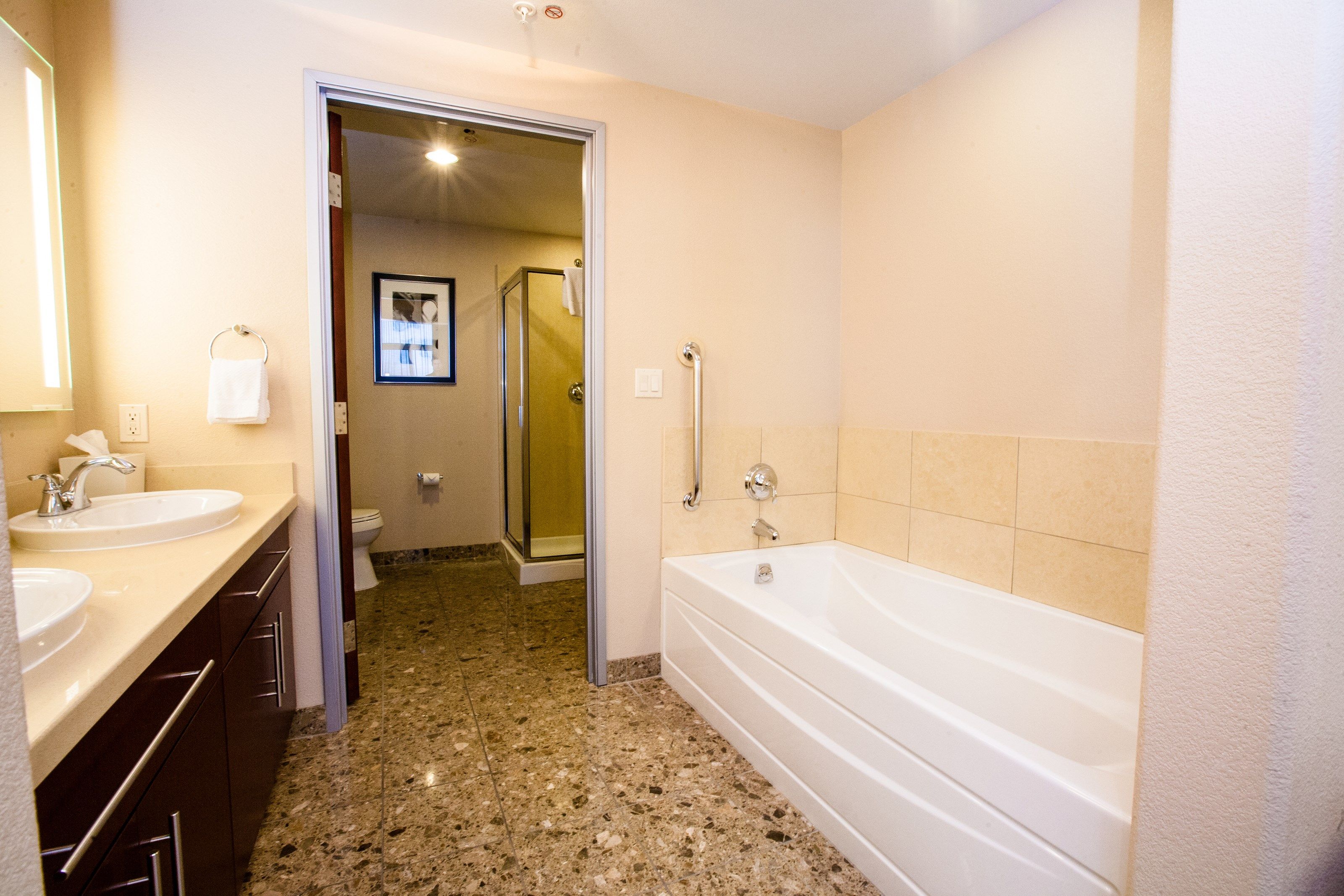 image This bathroom features a shower and tub combination.