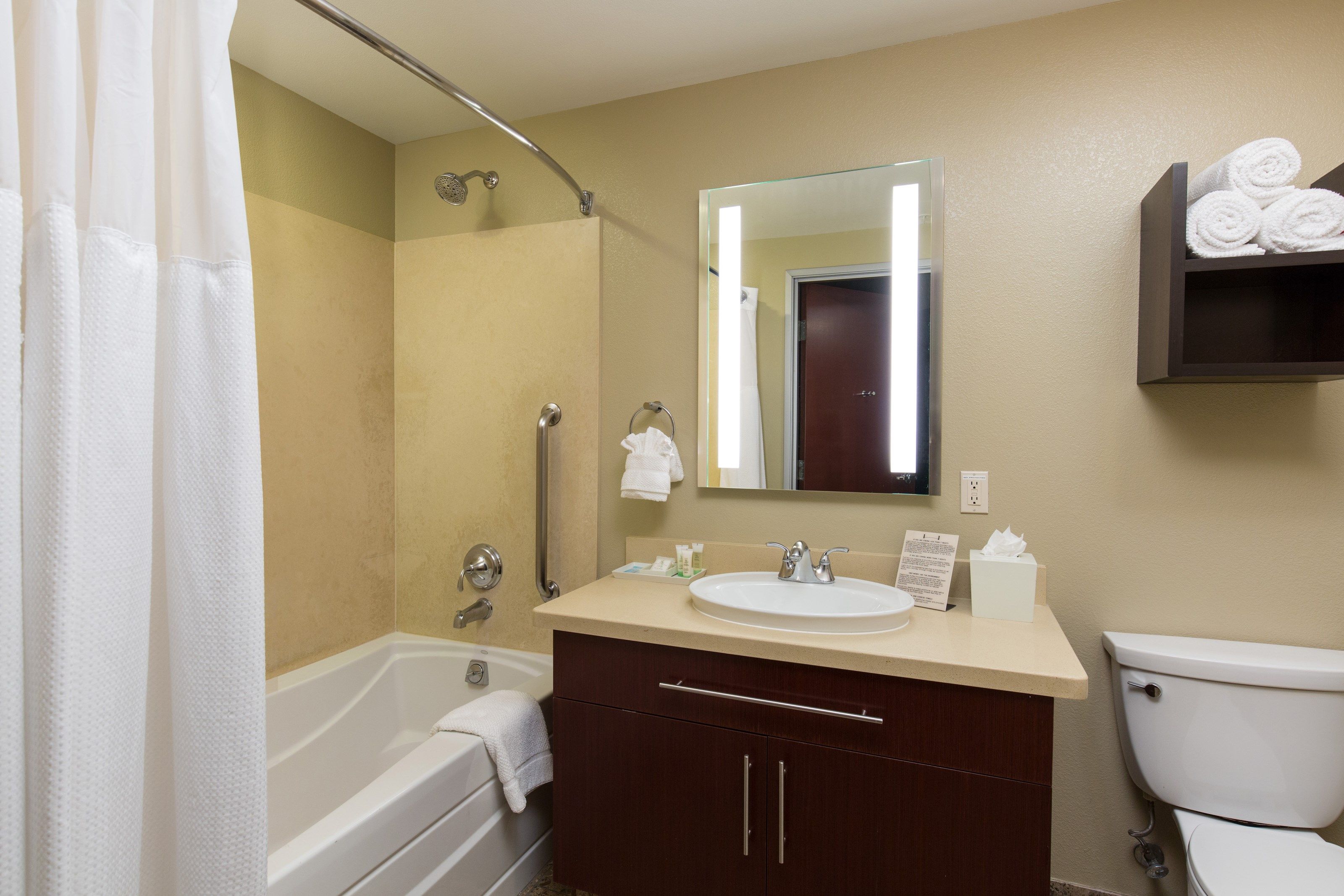 image This bathroom features a shower and tub combination.