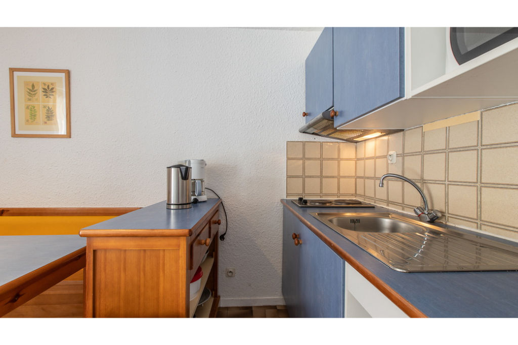 image Curb your appetite by cooking a meal in your kitchen.