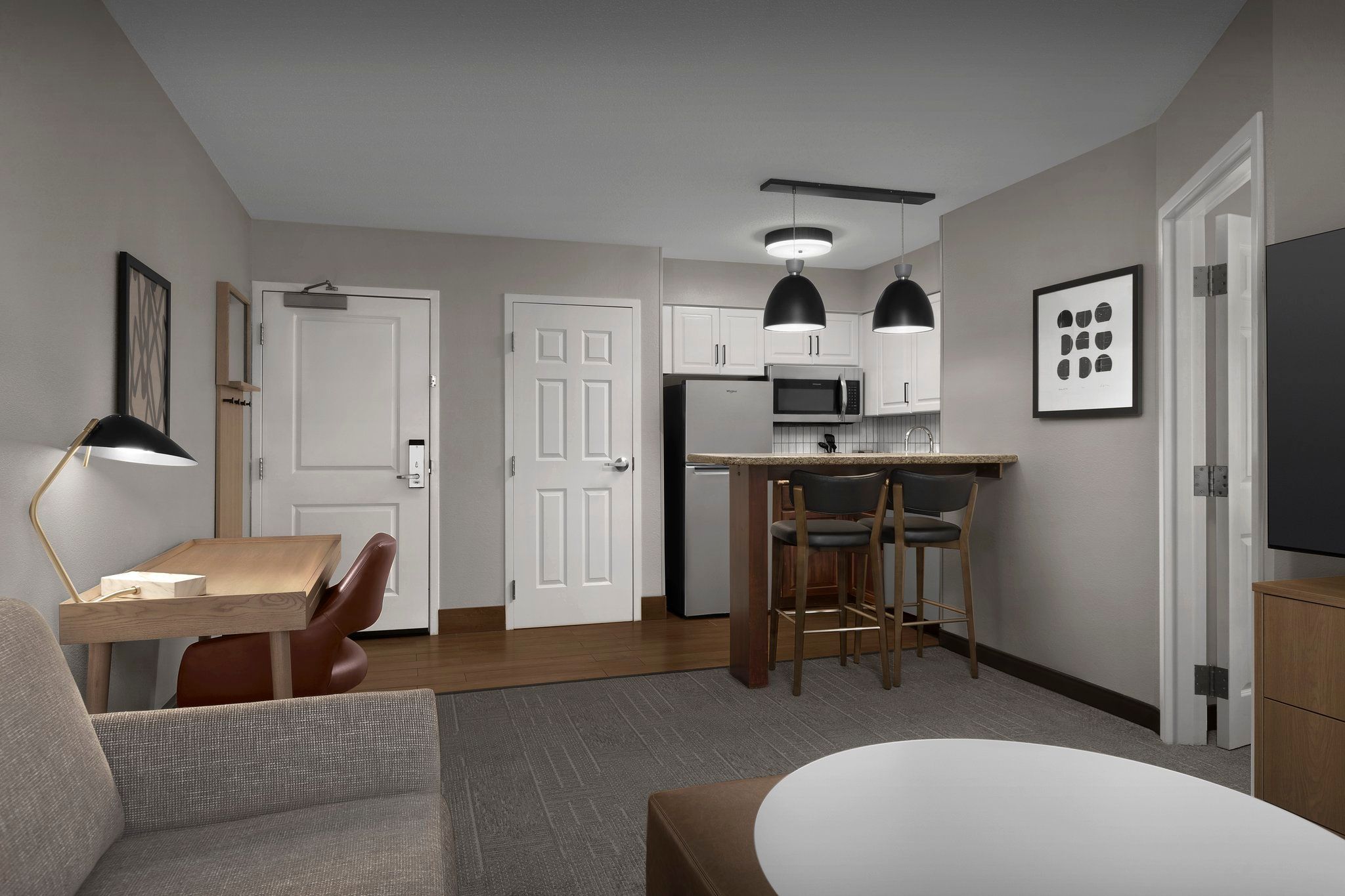 image Relax in the airy living space, featuring modern decor and a cozy kitchenette for your convenience.