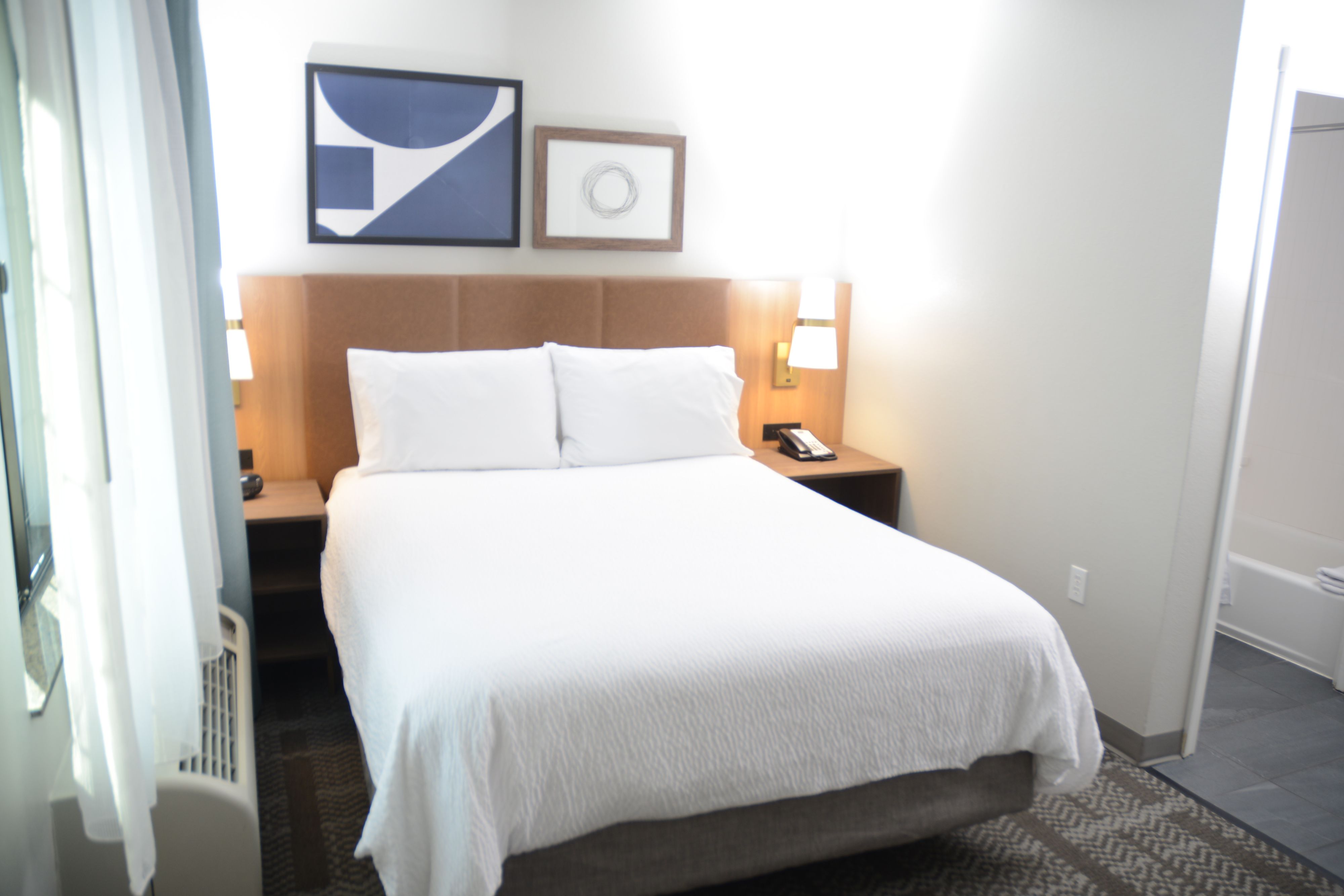 image Cozy bedroom featuring a queen bed and contemporary decor.