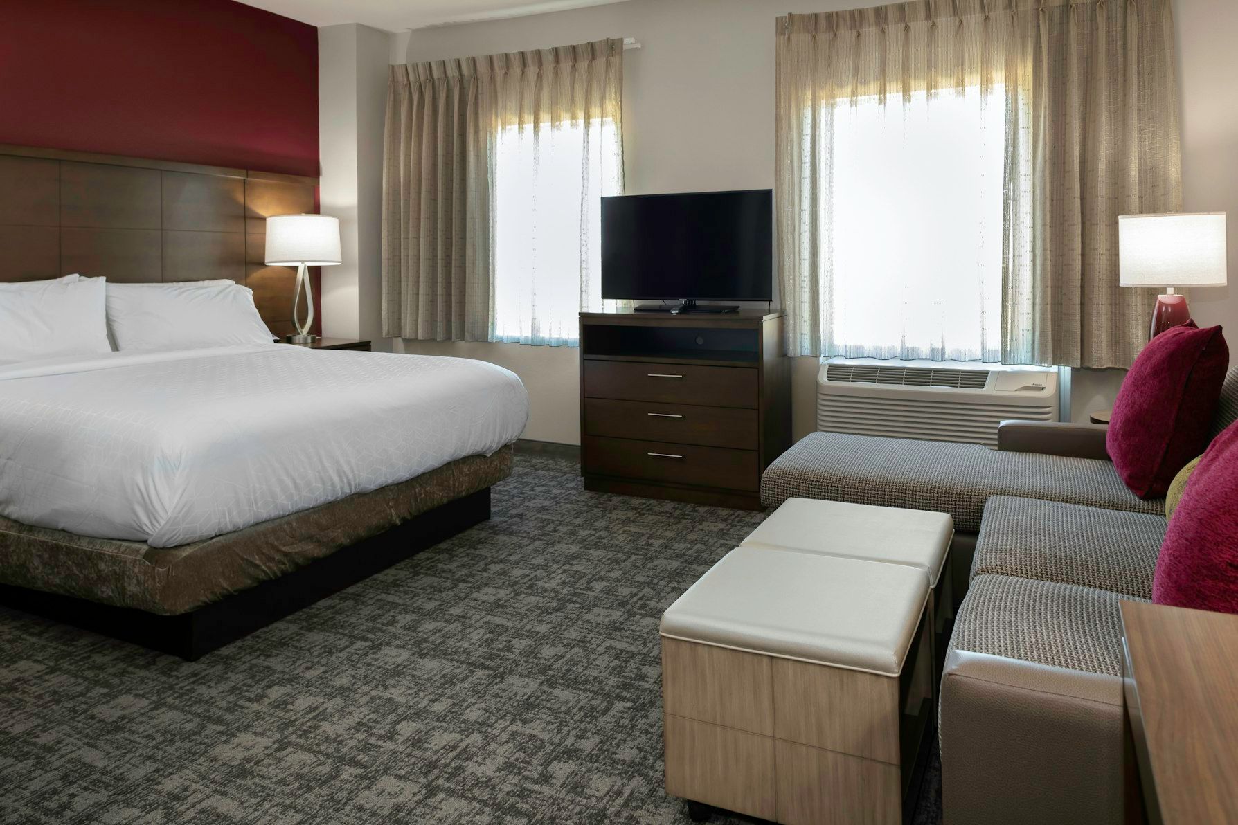 image Unwind in a spacious studio with a king bed and inviting seating, perfect for enjoying your morning coffee.
