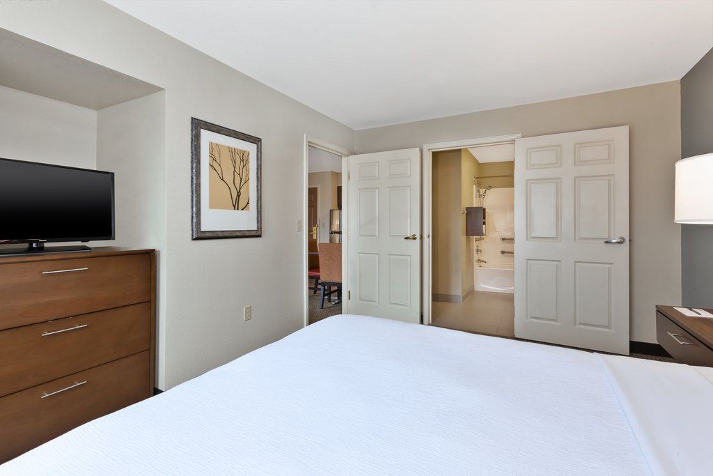 image Enjoy a peaceful night's sleep in a well-appointed bedroom featuring a comfortable bed and calming decor.