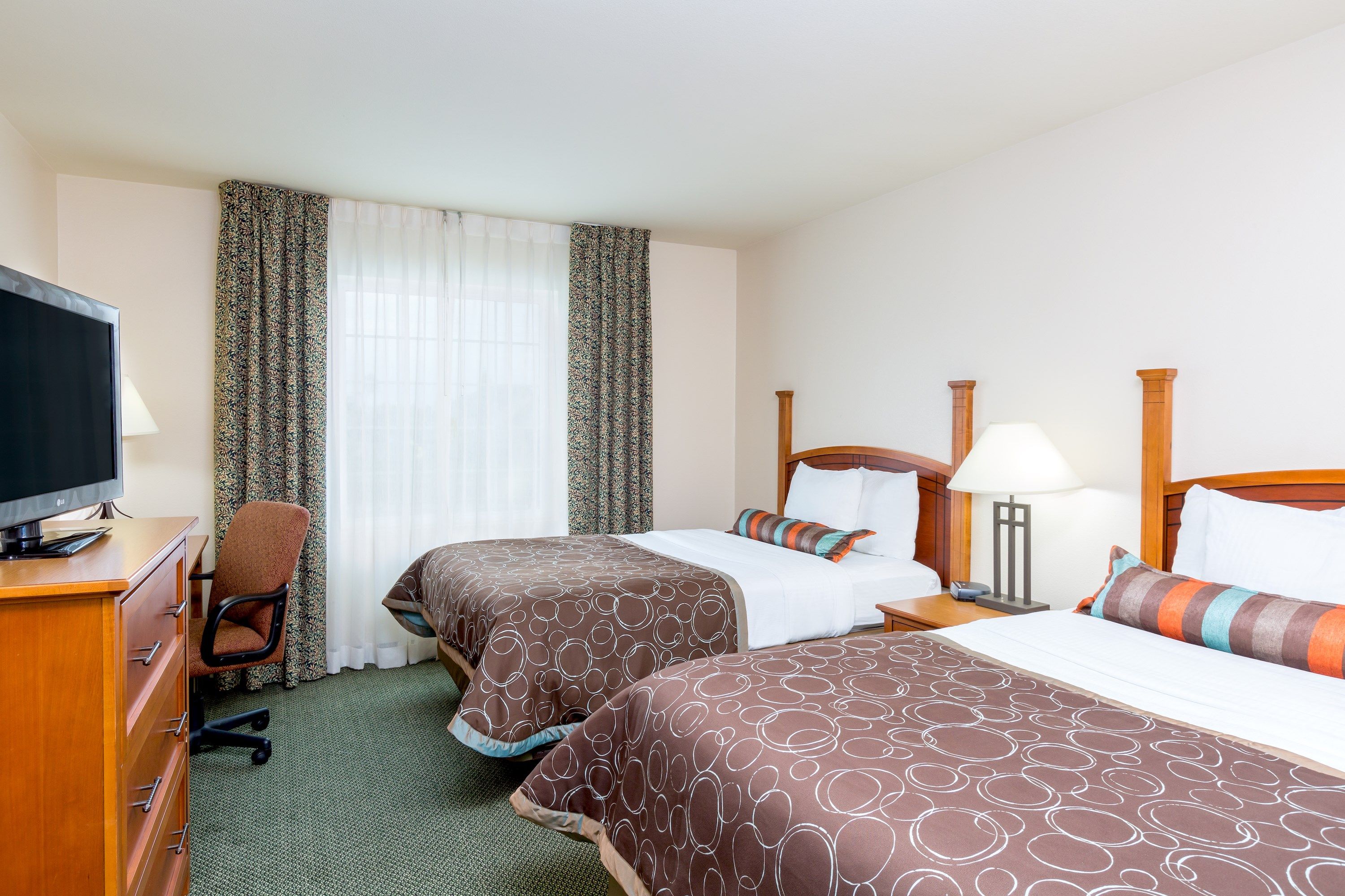 image Rest easy on two double beds with plush bedding and natural light pouring in.