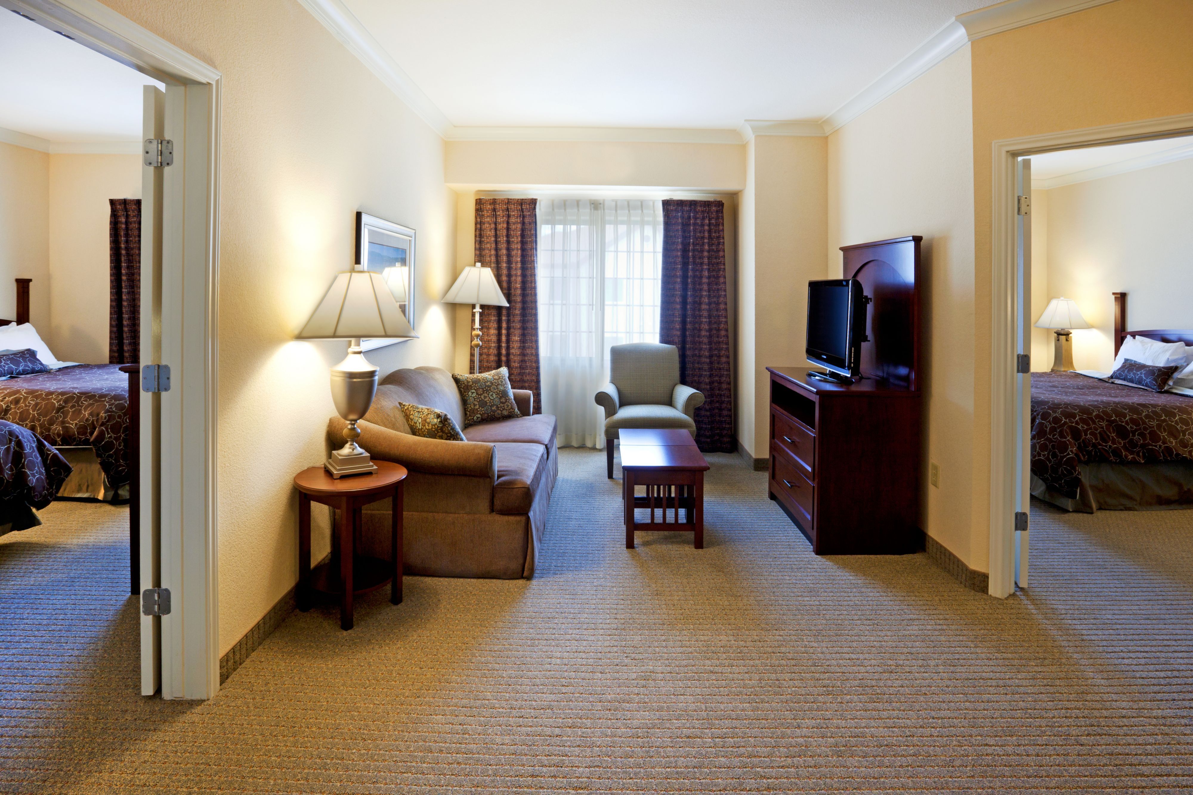 image Modern bedroom with natural light and comfortable furnishings.