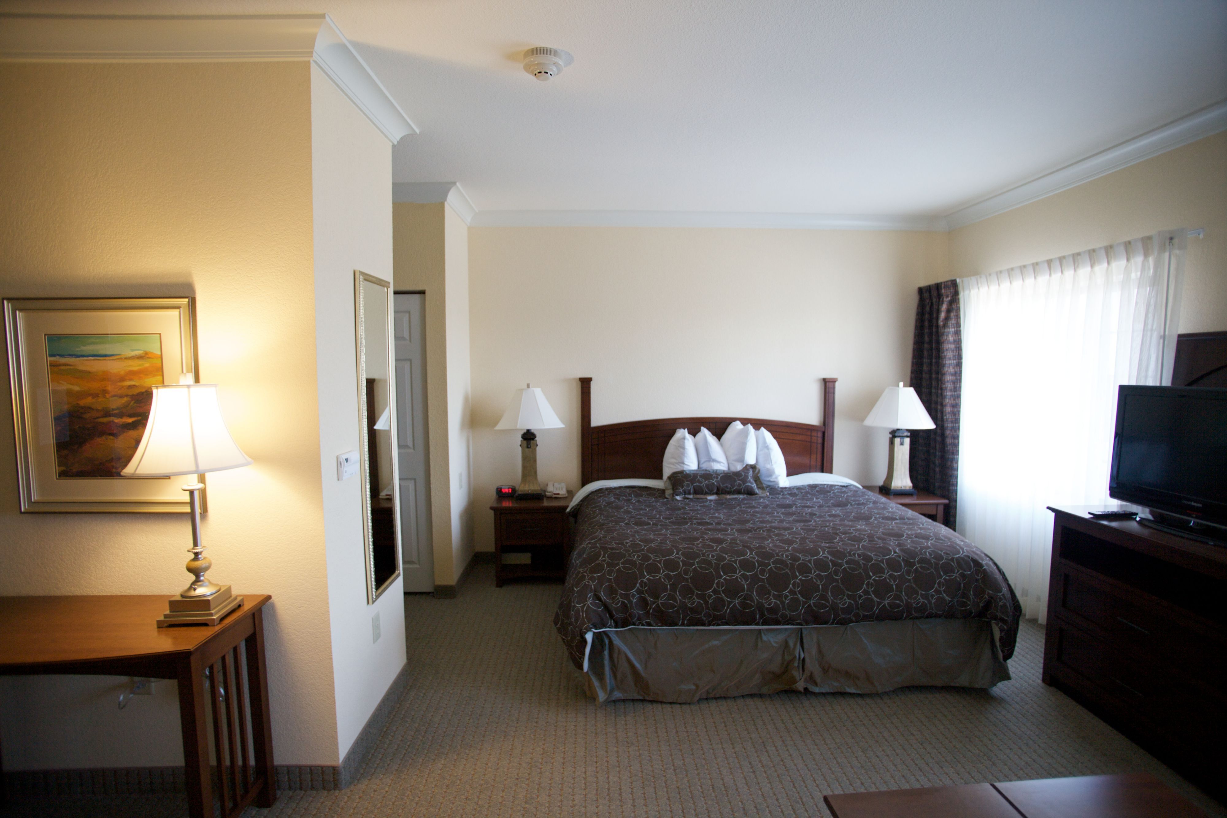 image Bright bedroom with soft lighting and elegant furnishings.