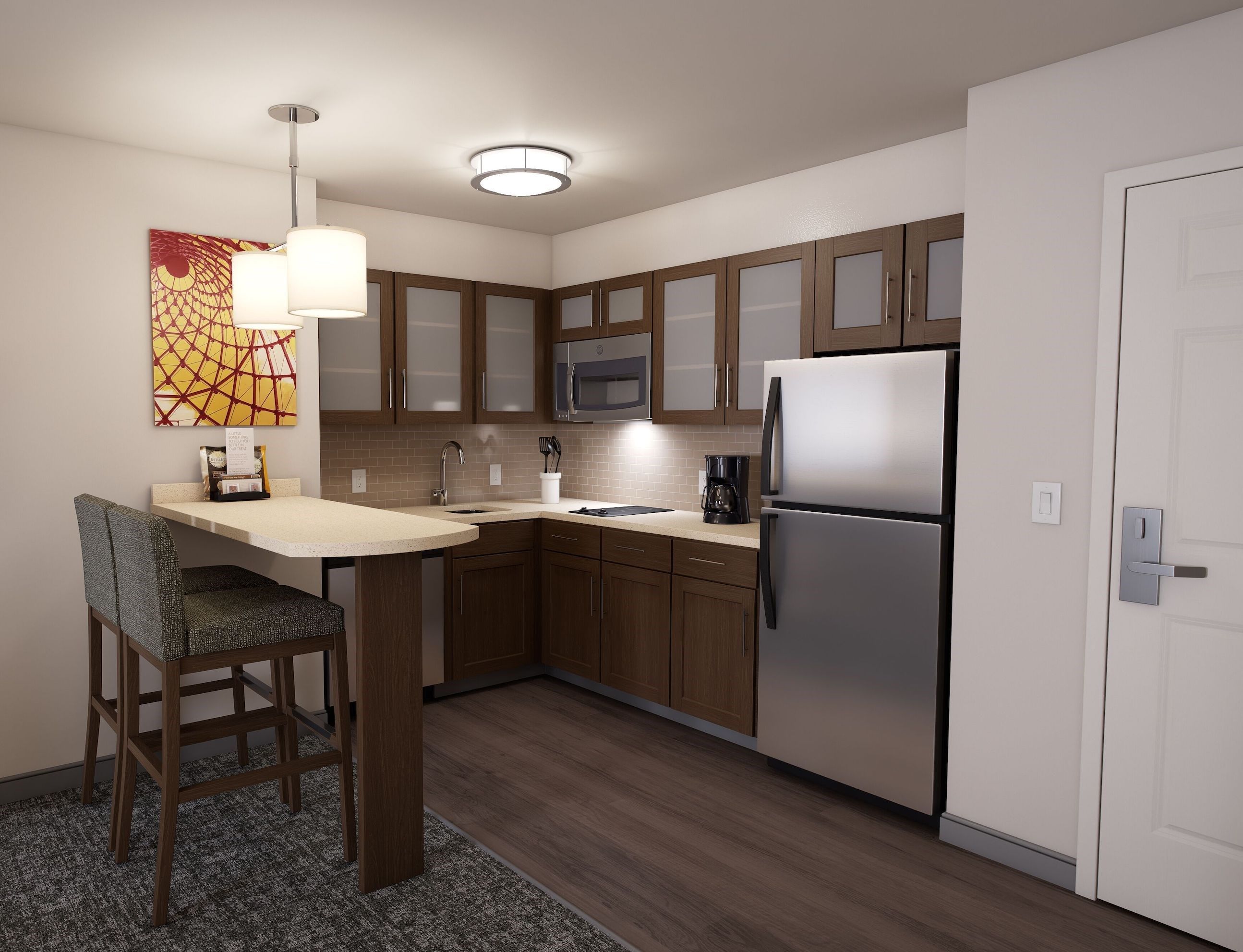 image The kitchen area includes a full-size refrigerator, microwave, stovetop, and modern cabinetry for convenient meal preparation.