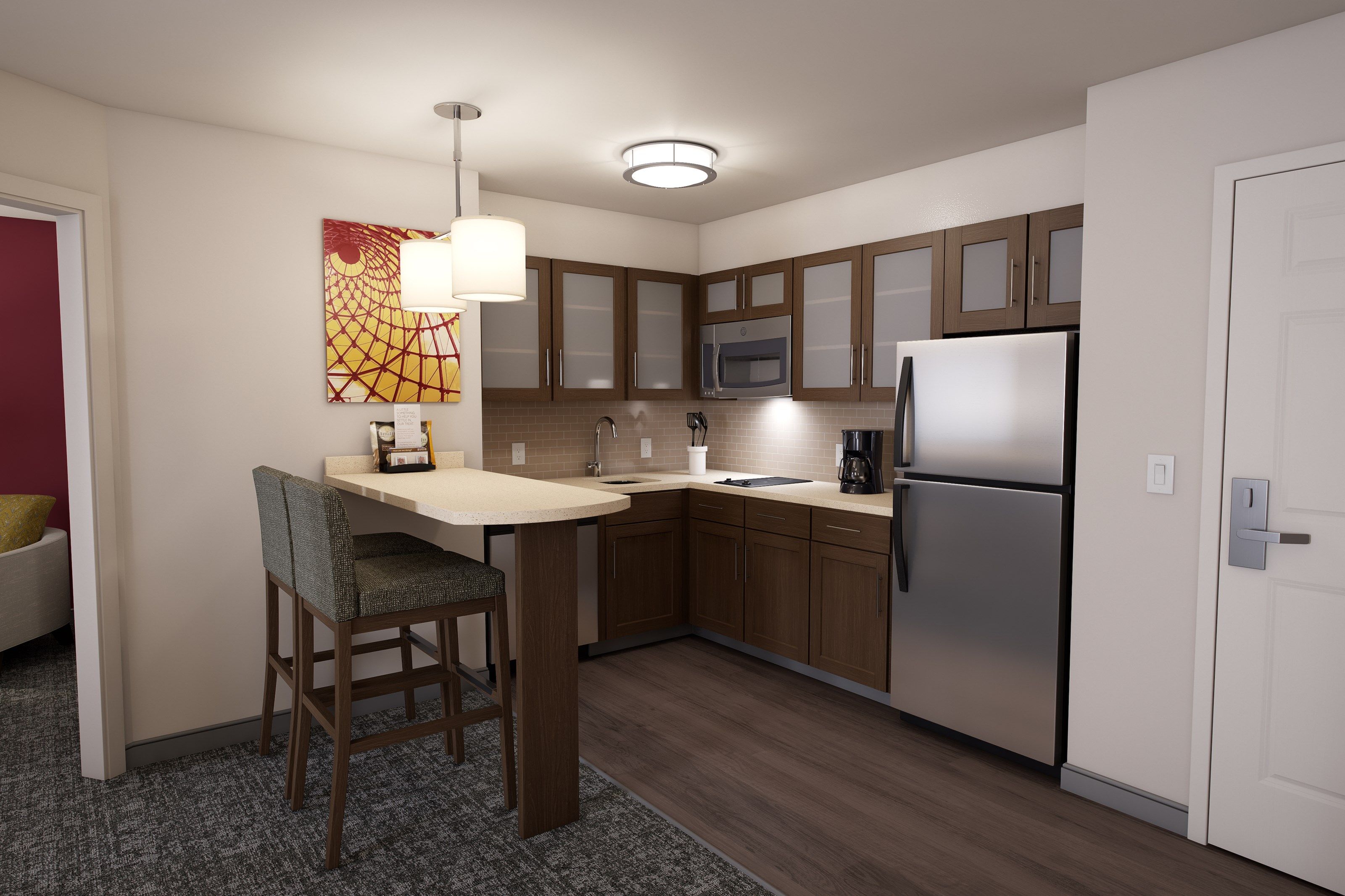 image The kitchen features modern cabinetry, sleek stainless steel appliances, and a cozy bar area with stylish seating.