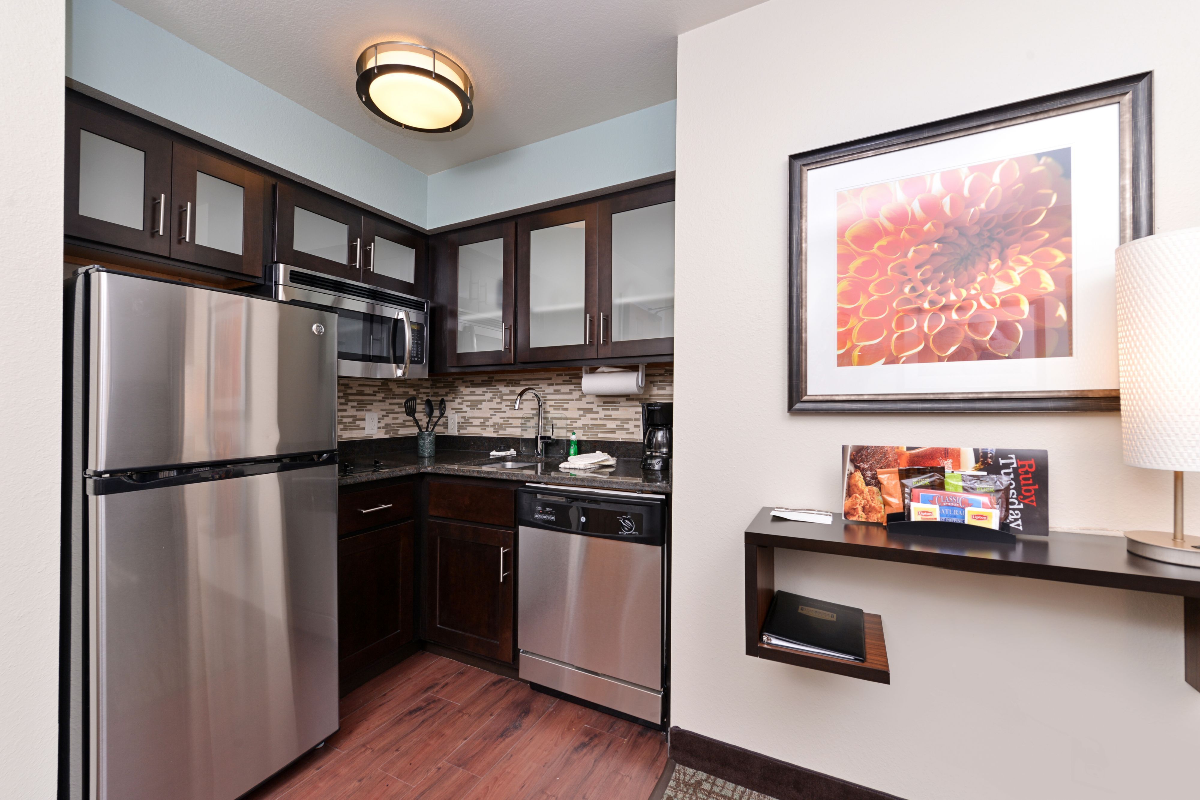 image Modern kitchenette with stainless steel appliances and plenty of storage.