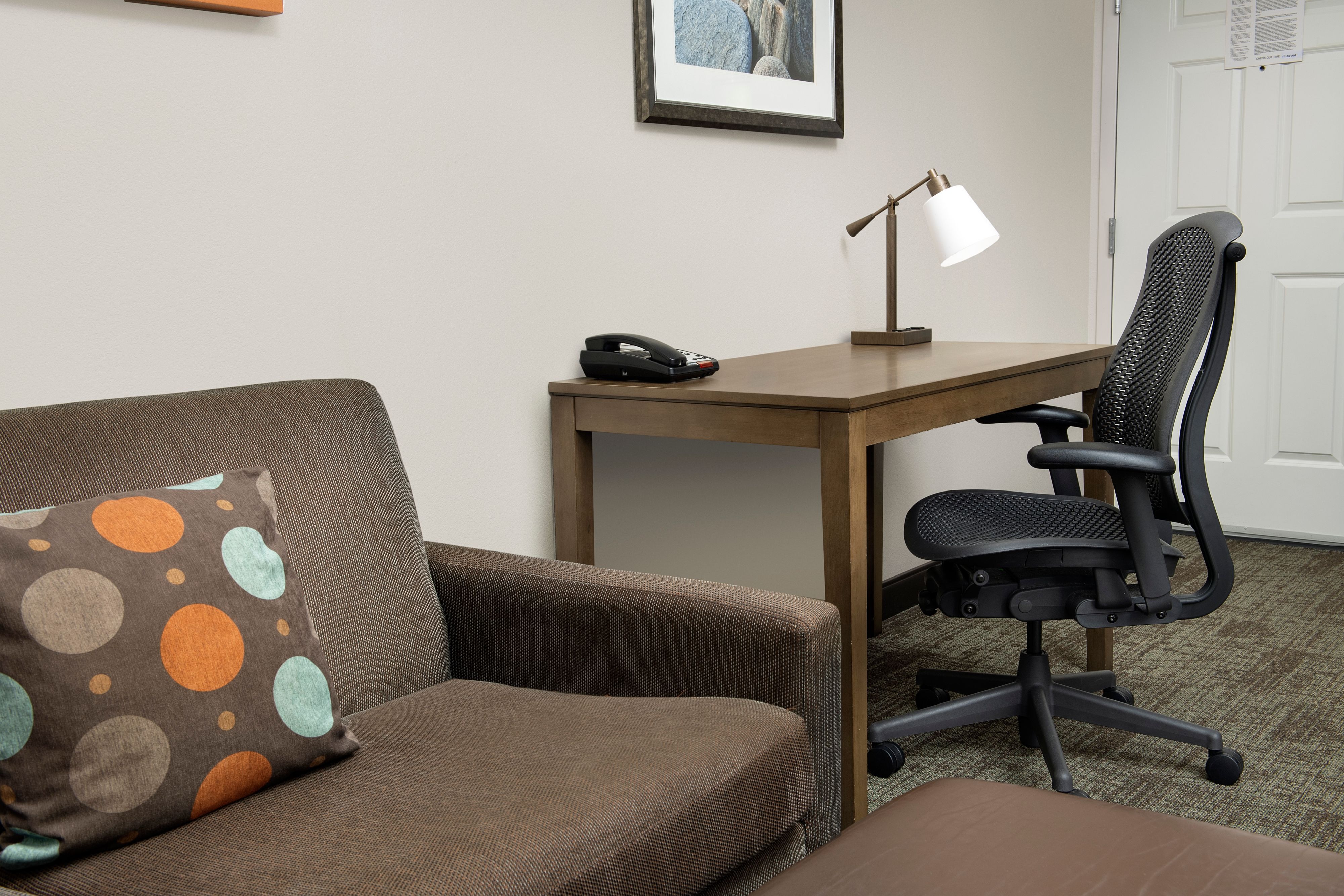 image Bright seating area with work desk and ample natural light.