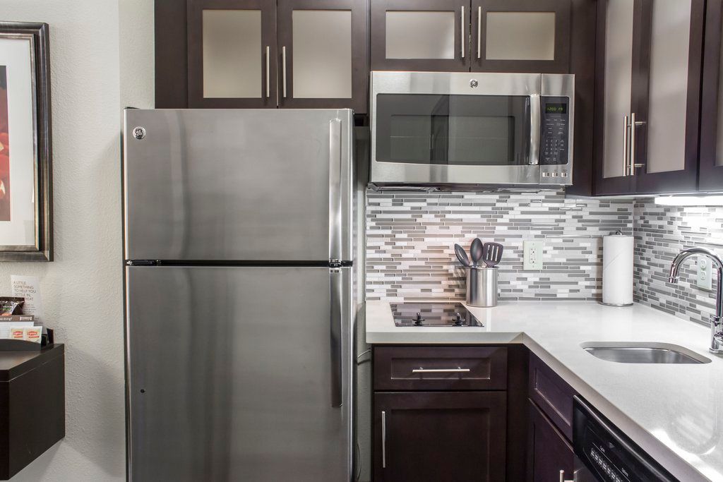 image Embrace culinary adventures in a sleek kitchen featuring modern appliances and elegant storage for all your cooking essentials.