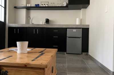 The small kitchenette features ample counter space for you to prepare drinks and snacks.