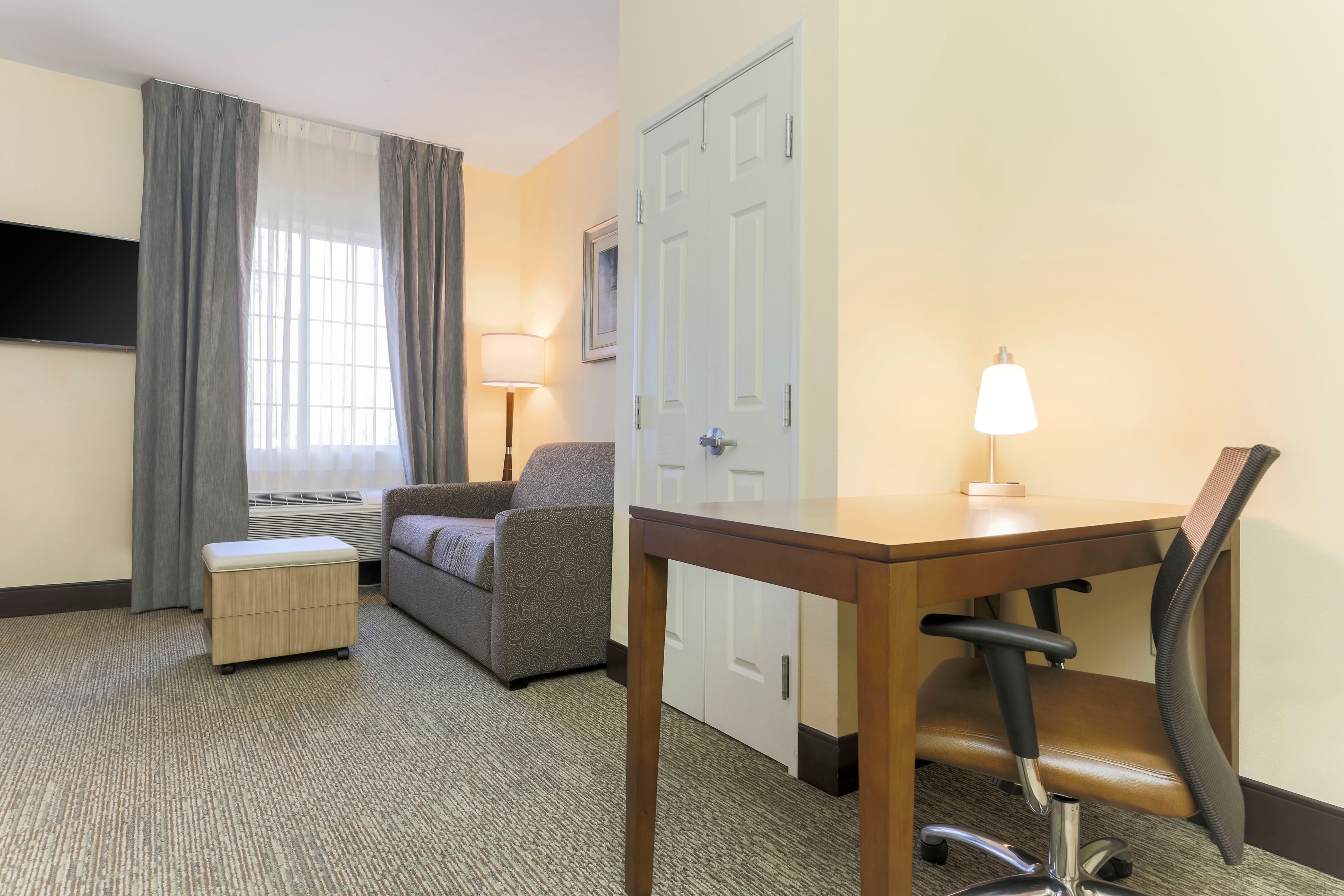 image Catch up on work or relax in the bright sitting area with a sofa and TV.