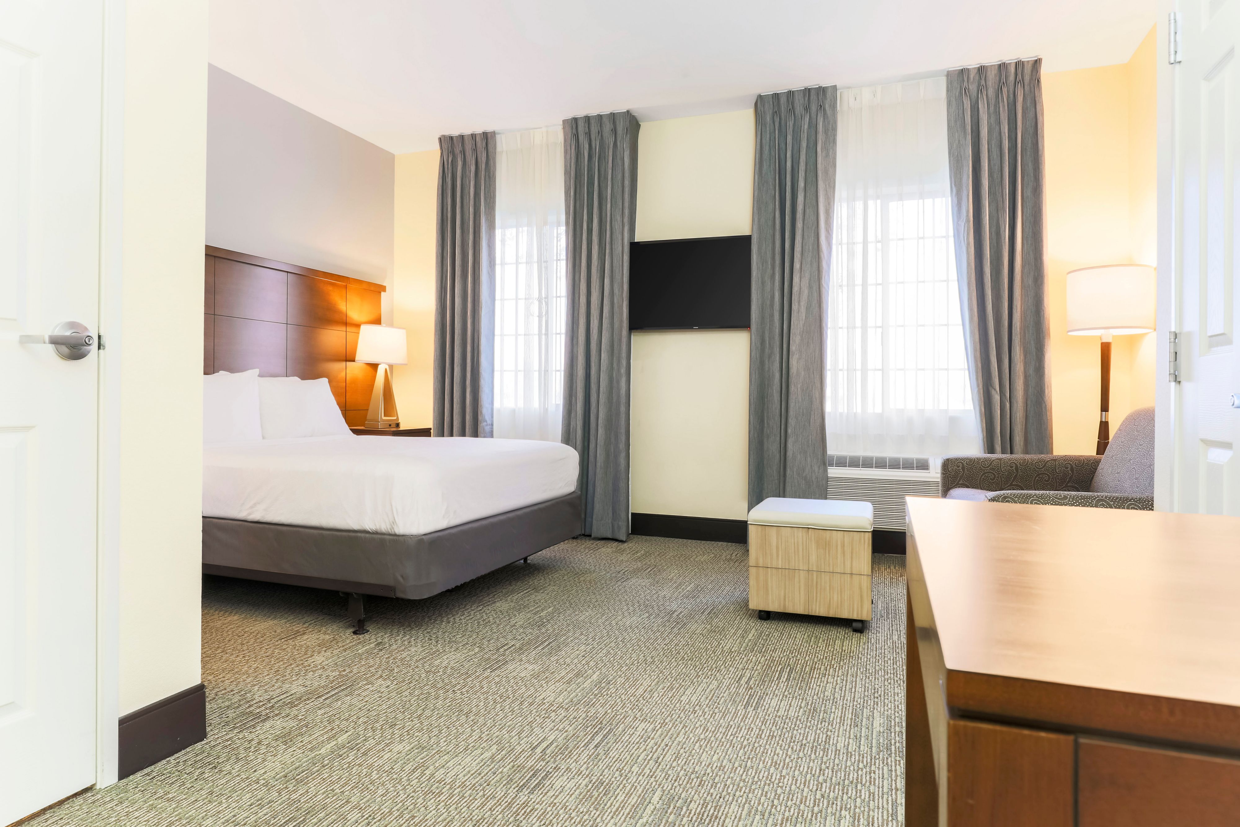 image Unwind in the studio's queen bed and cozy seating area.