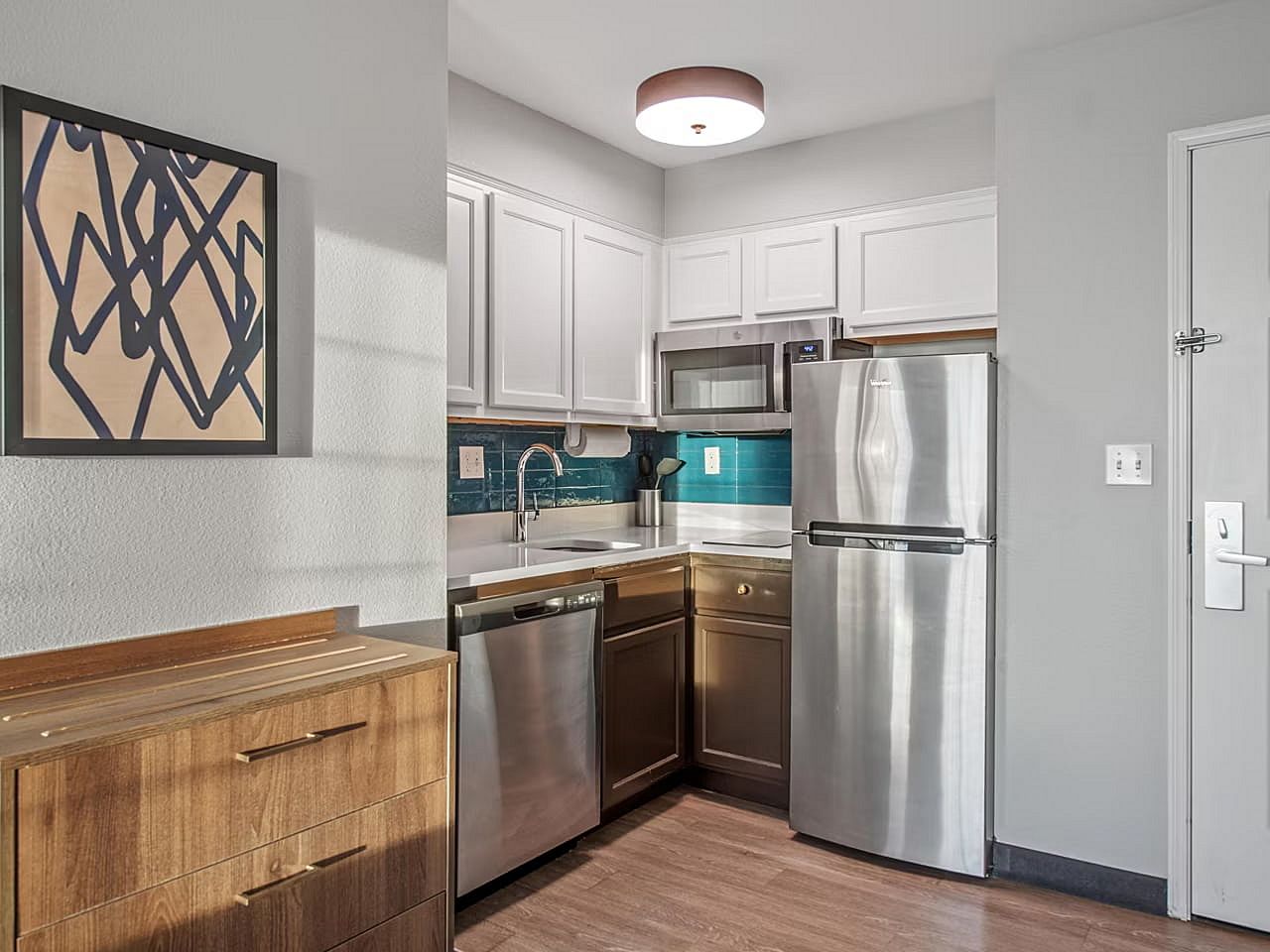 image Create culinary delights in this sleek, fully-equipped kitchen with modern finishes for a perfect stay.