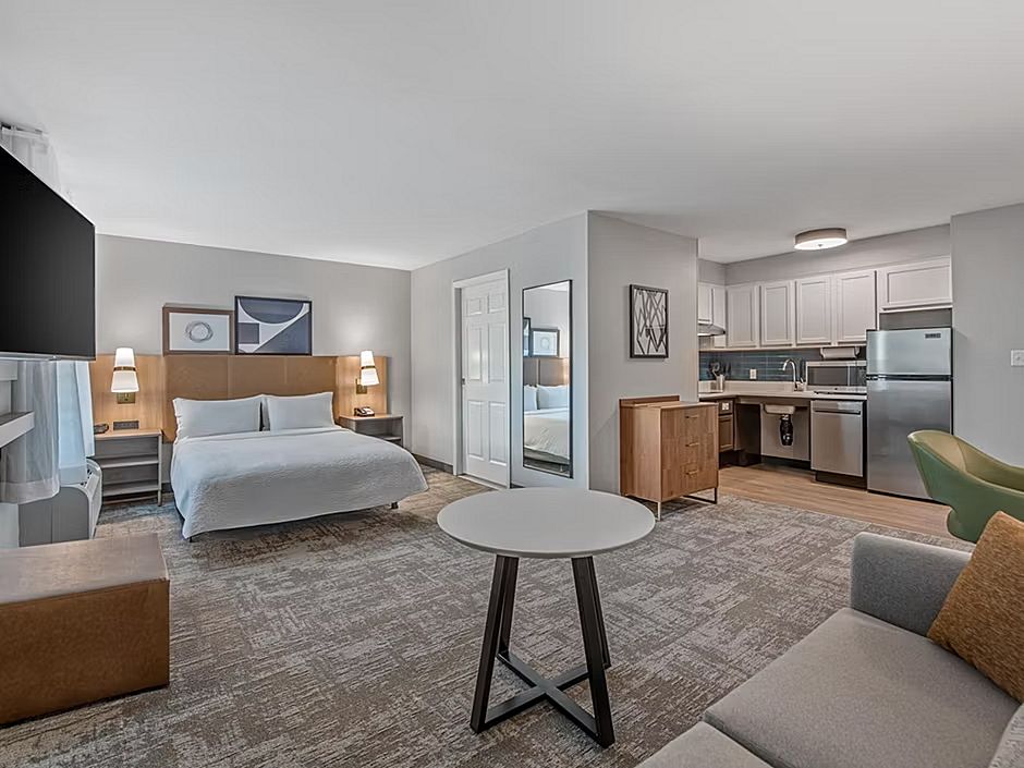 image Enjoy the open layout of this comfortable suite, complete with a kitchen, workspace, and inviting seating area.