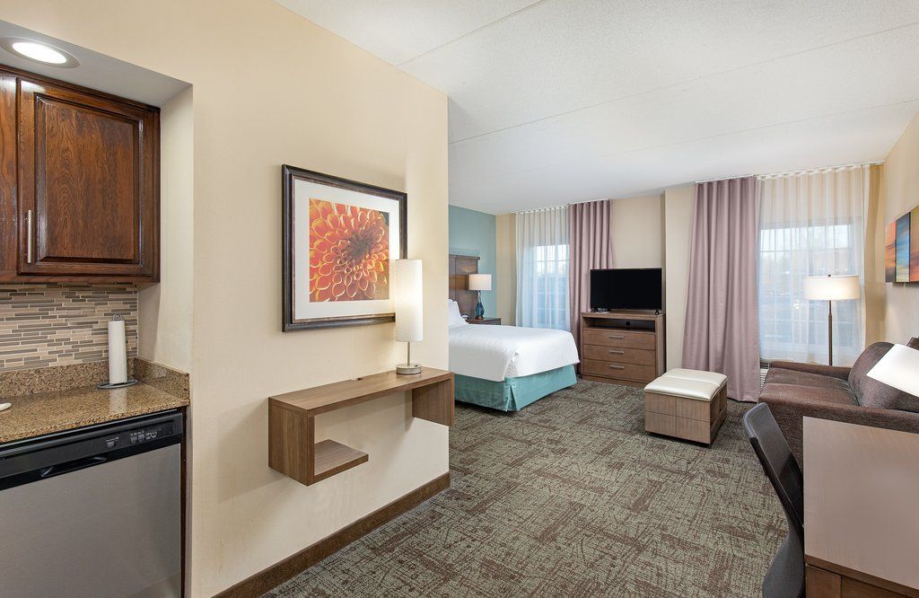 image Enjoy the convenience of a cozy Studio Suite, complete with a kitchen, relaxing seating area, and inviting ambiance for the perfect stay.