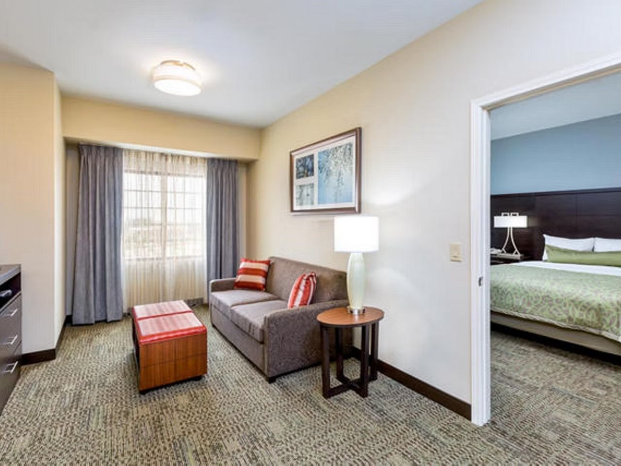 image Living area with a comfortable sofa, side lamp, and natural light — with the bedroom just steps away.