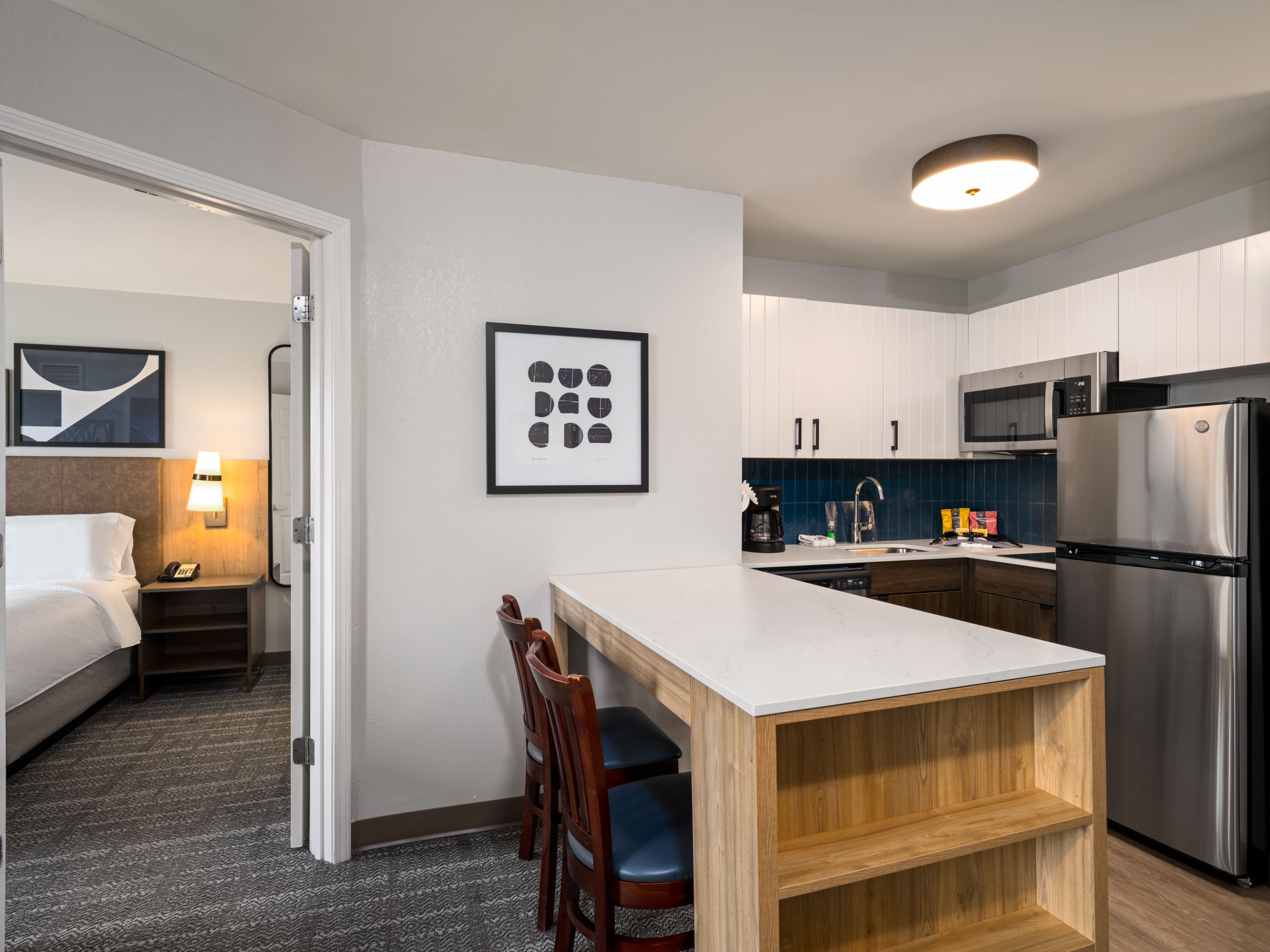 image Kitchen with appliances, seating area, and doorway