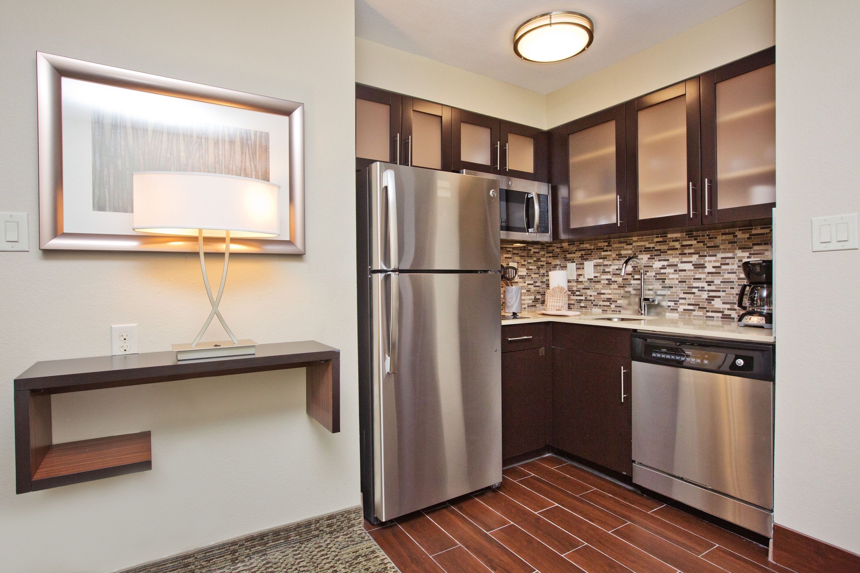 image Kitchen with stainless steel appliances, cabinetry, and countertop sink.