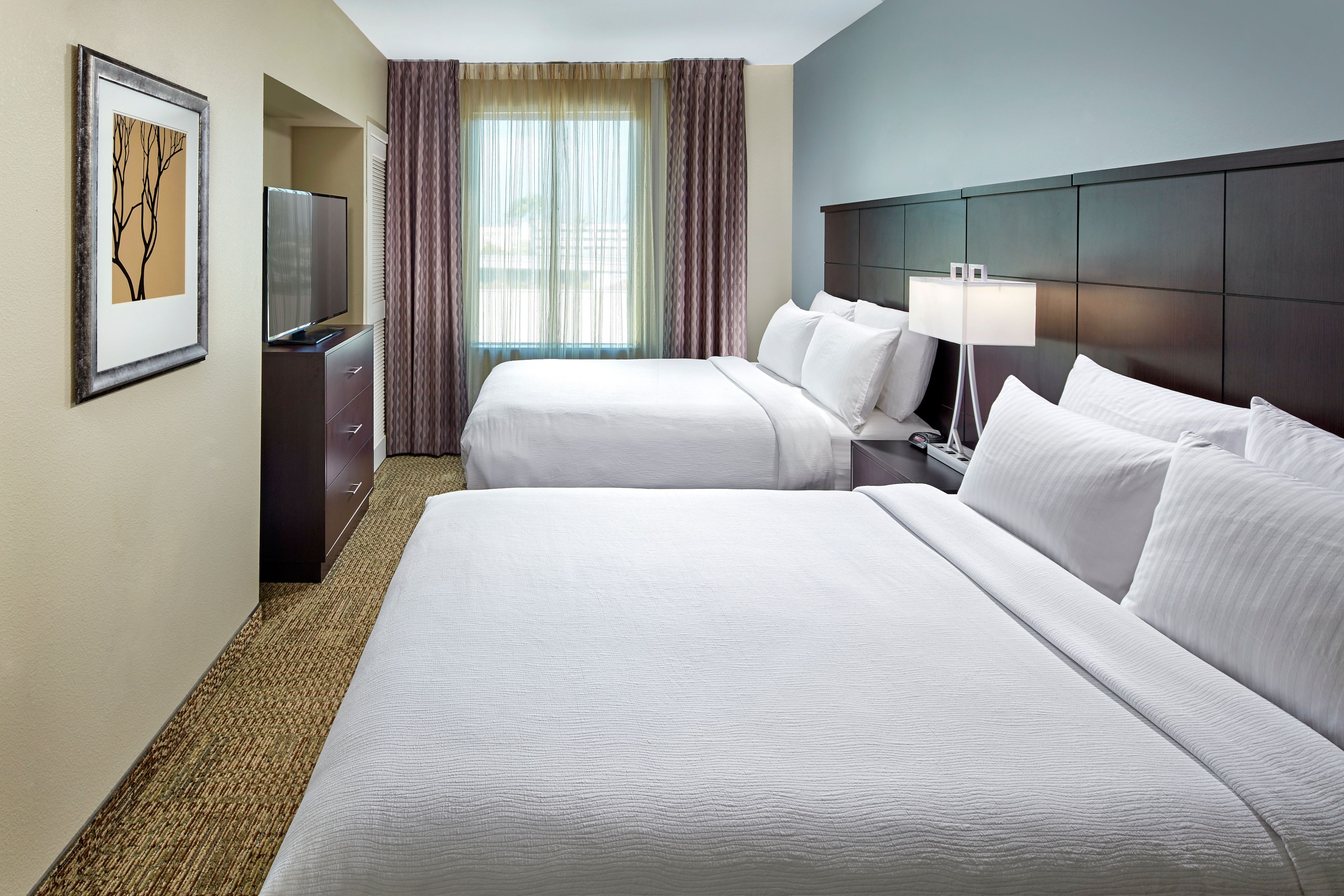 image Bedroom with two queen beds and flat-screen TV.