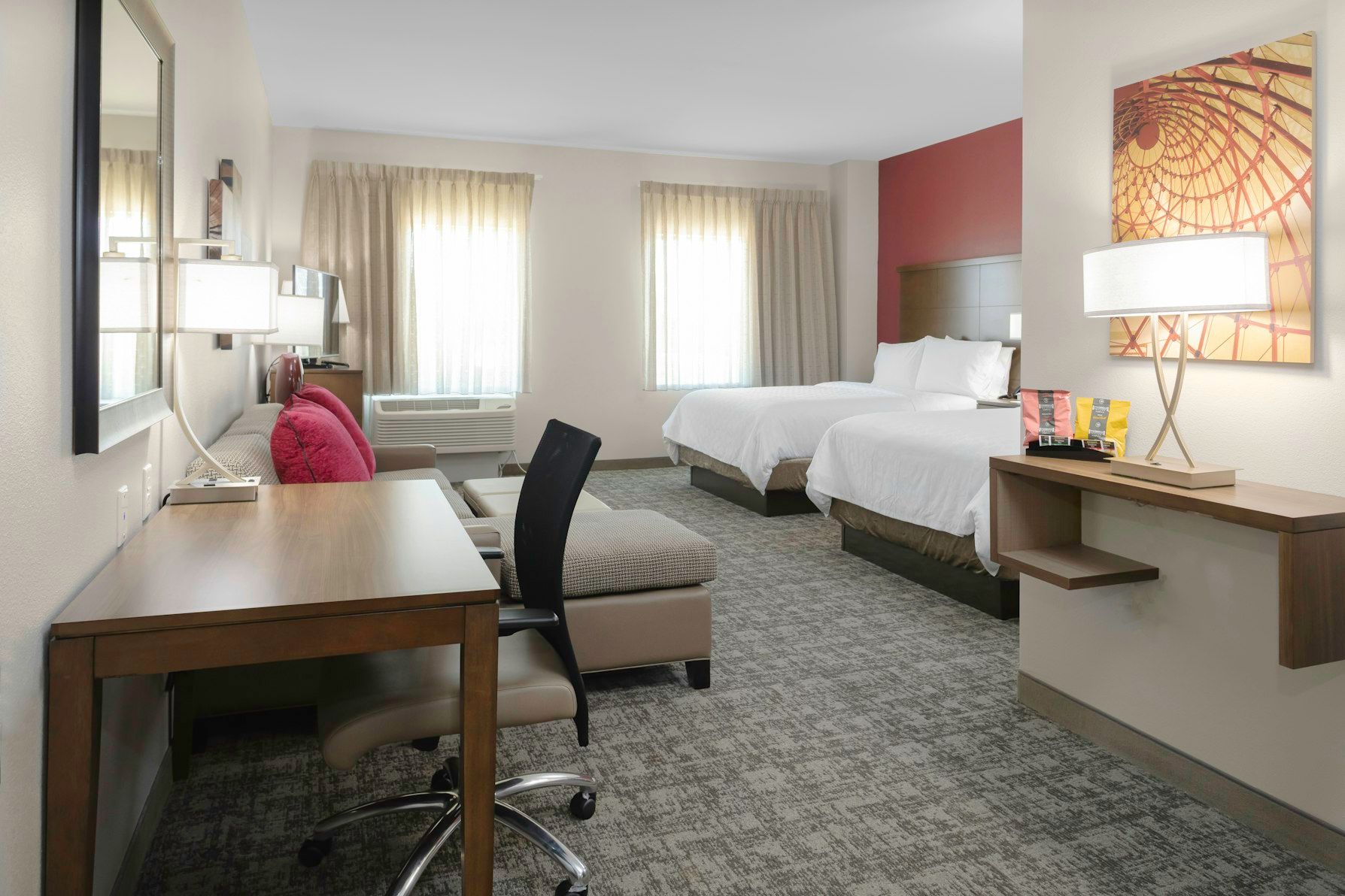 image Relax in this cozy studio suite, featuring two inviting queen beds and a bright, airy atmosphere.
