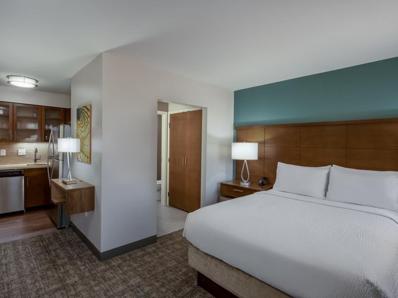 image Open-plan studio with queen bed, kitchen, and bathroom access.