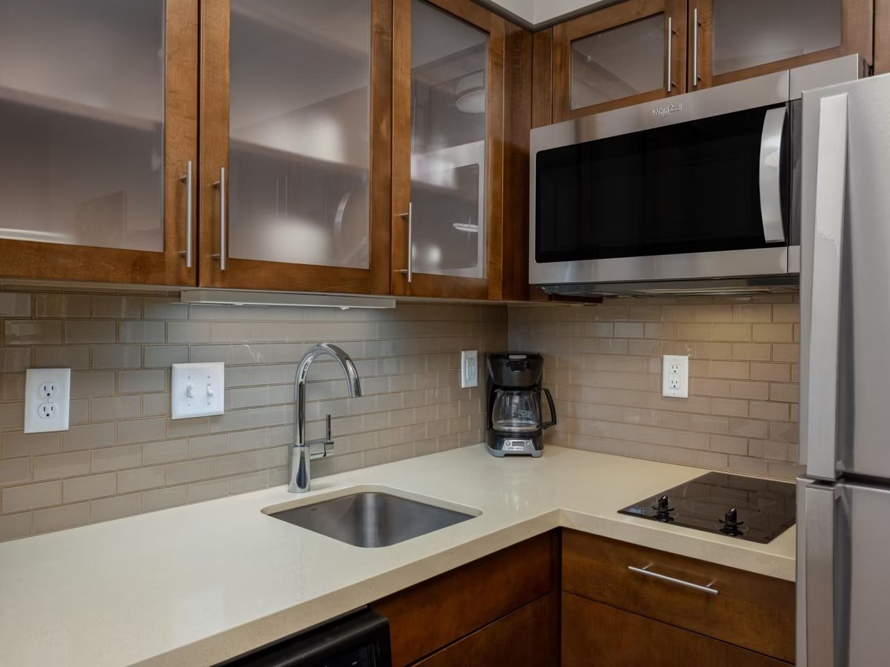 image The fully equipped kitchen includes a stove, microwave, sink, and coffee maker.