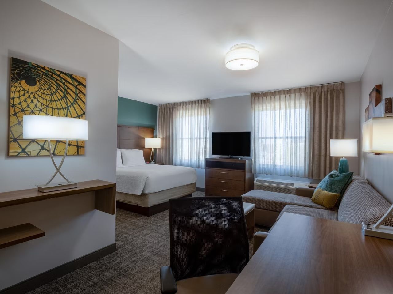 image The studio features a queen bed, sofa, workspace, and flat-screen TV.