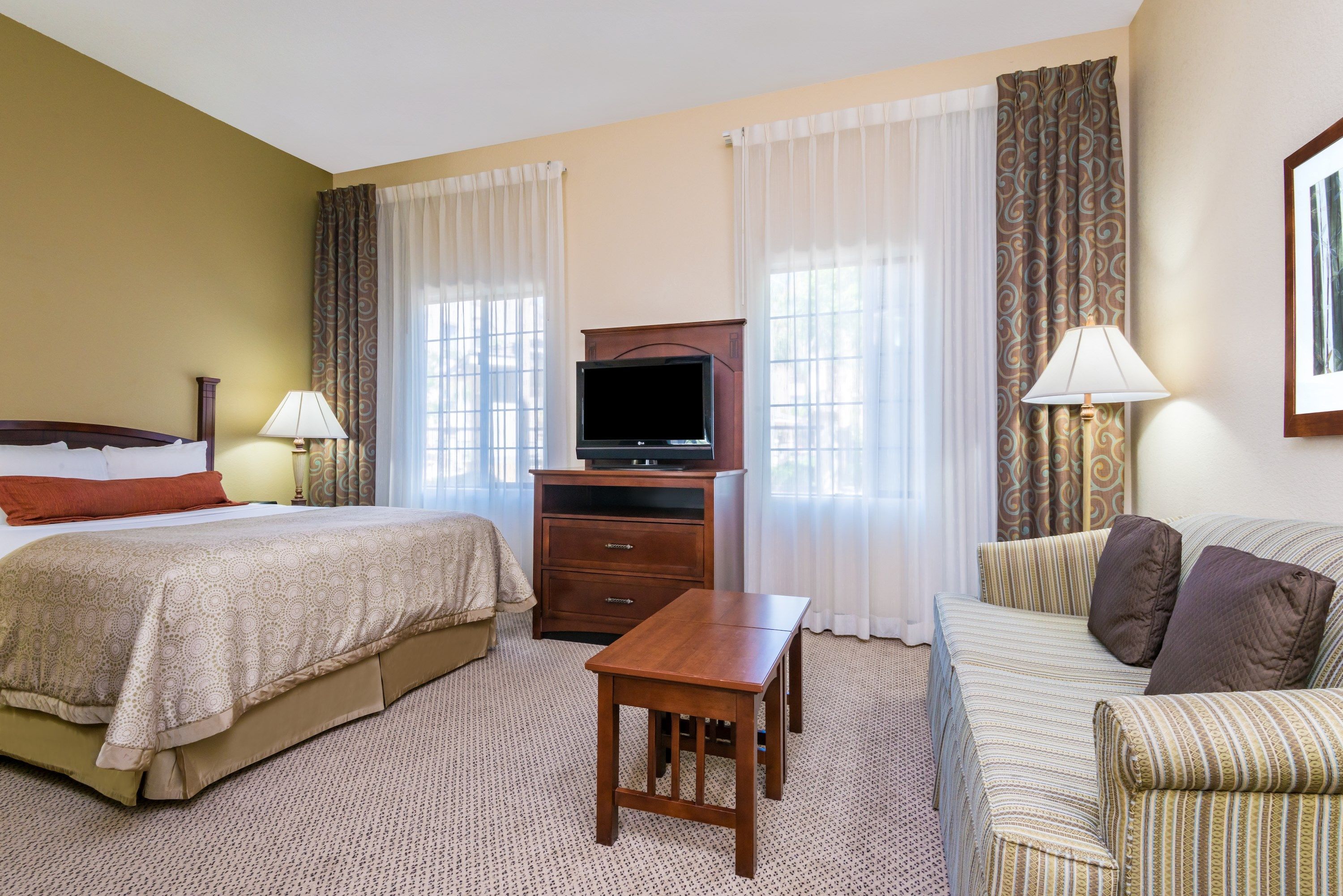 image Comfortable bedroom with cozy bed and seating area.