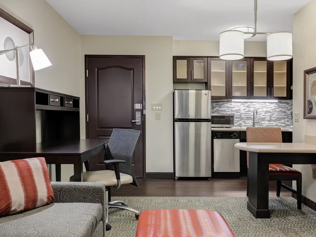 image Enjoy a cozy living space with a desk and comfortable seating.