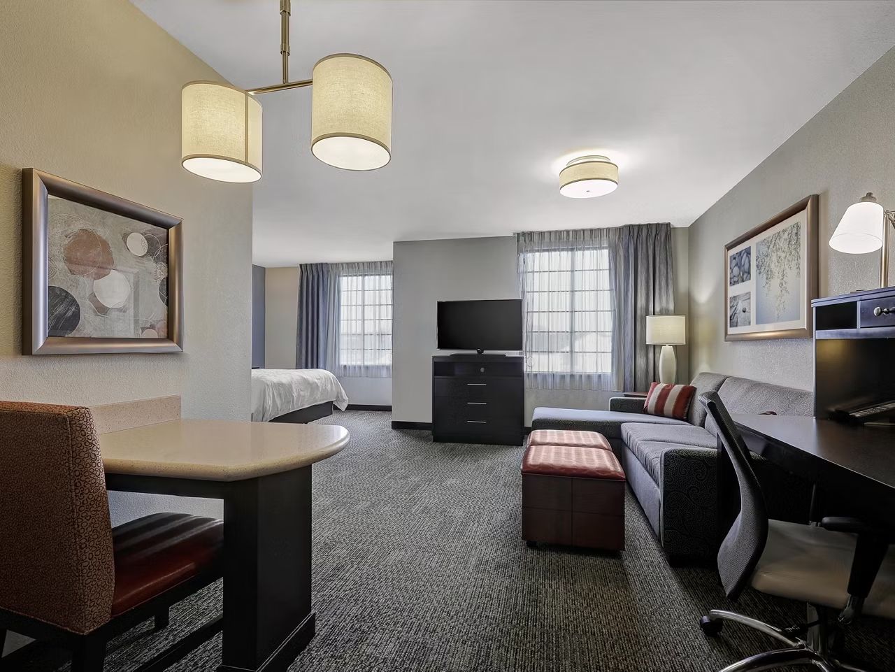 image Stylish studio suite with cozy seating and a workspace.
