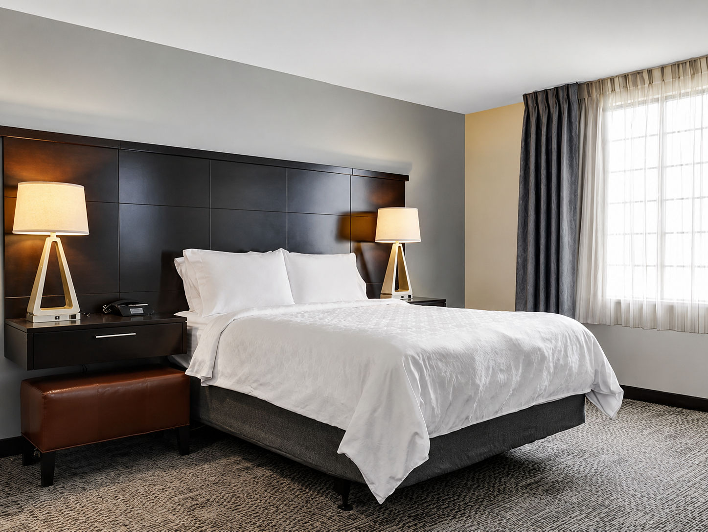 image Bright, comfortable bed and warm bedside lighting.