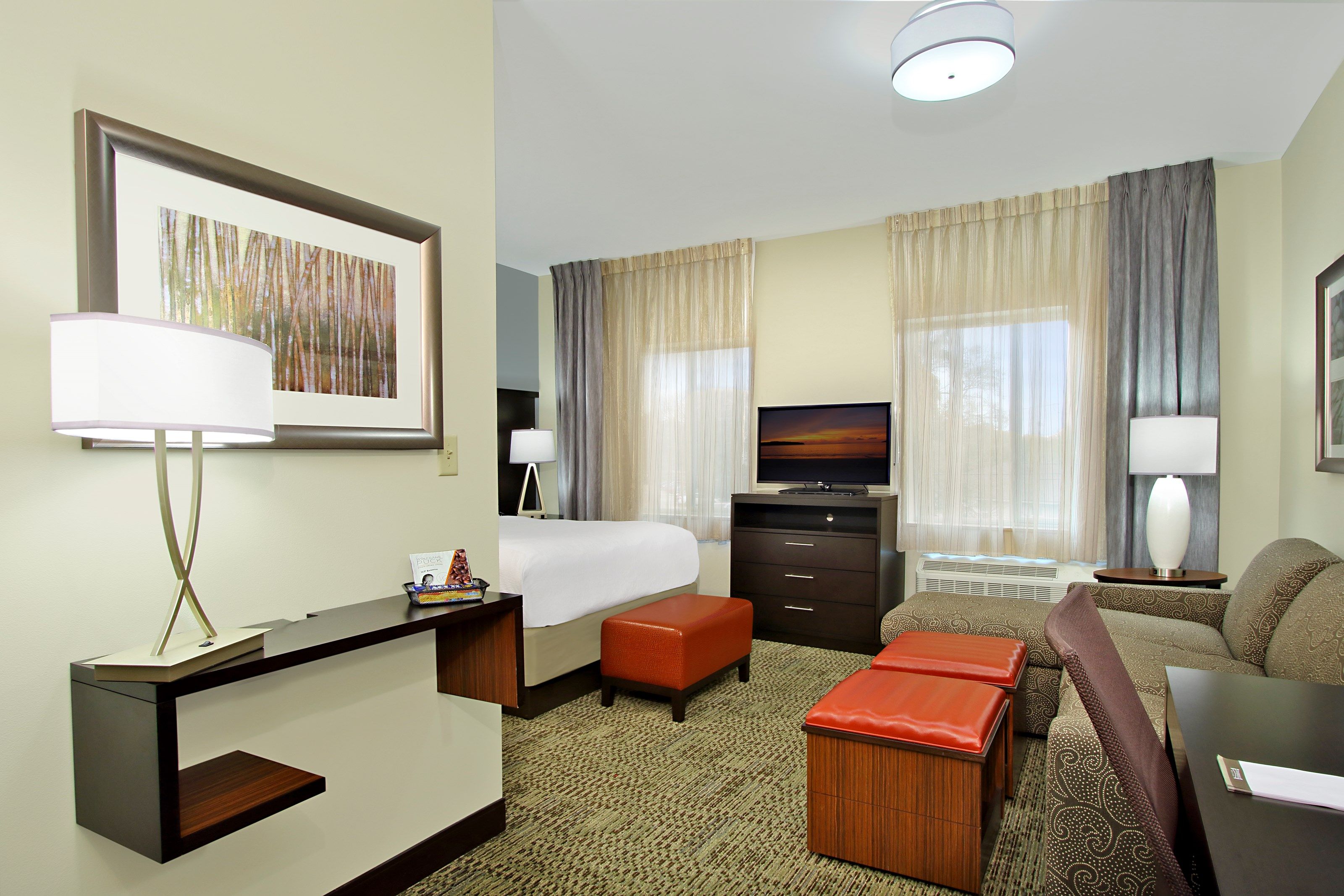 image Queen bed with accessible layout in an open studio — space thoughtfully designed for extended stays near the Medical Center
