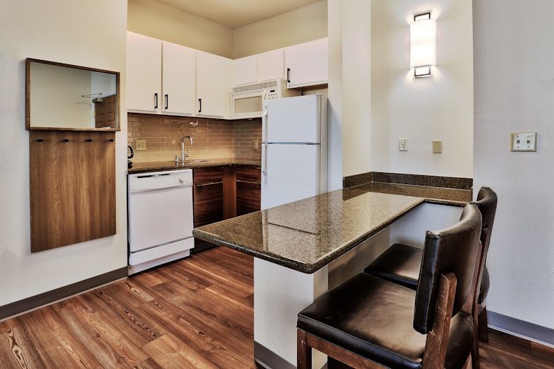 image Fully equipped kitchen with bar seating, ready for easy home cooking