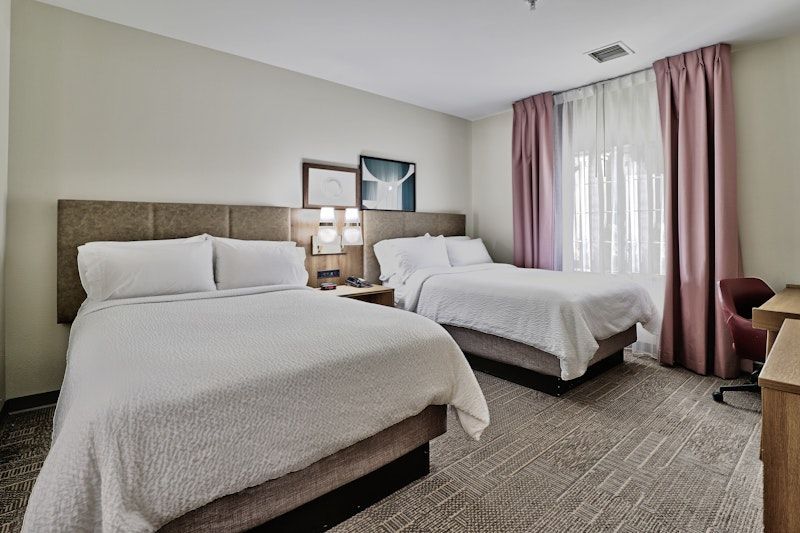 image Two-bed room with natural light, comfortable for families or groups