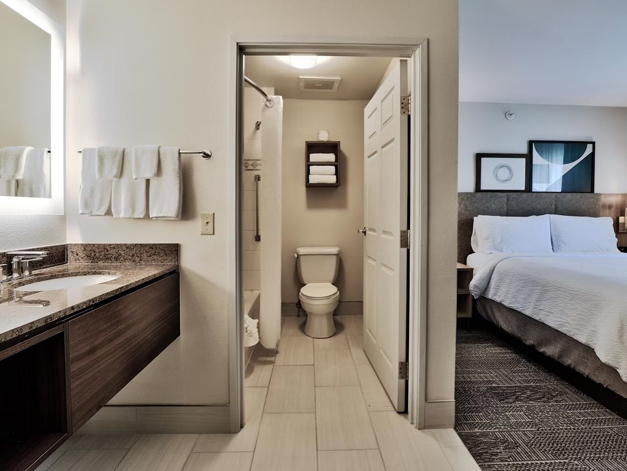 image Bright bathroom with a shower/tub combo, plush towels, hair dryer, and complimentary toiletries