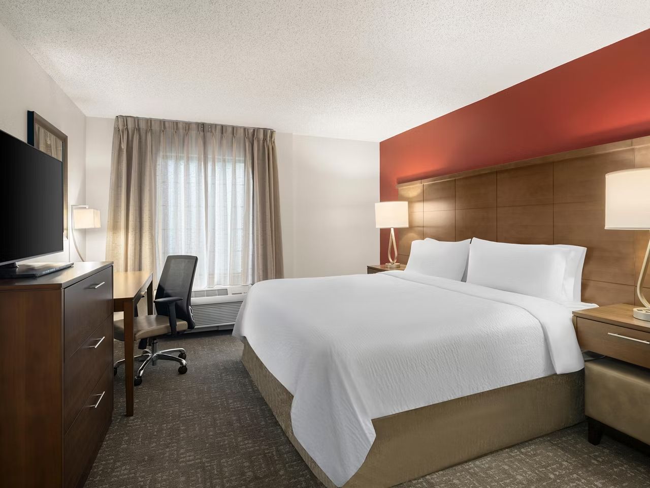 image Inviting bedroom with a large bed and workspace.